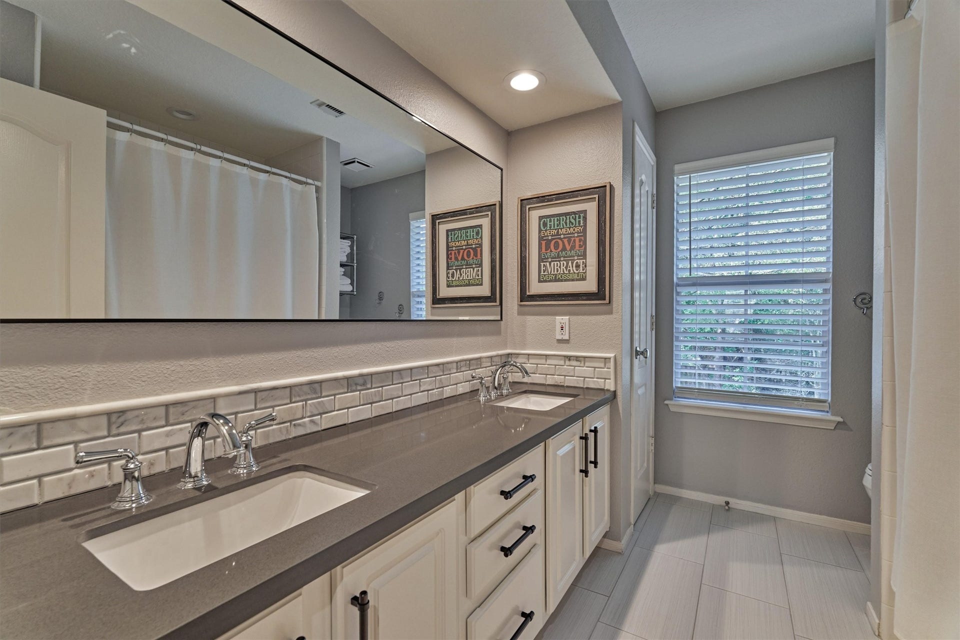 Full secondary bathroom featuring dual sinks!