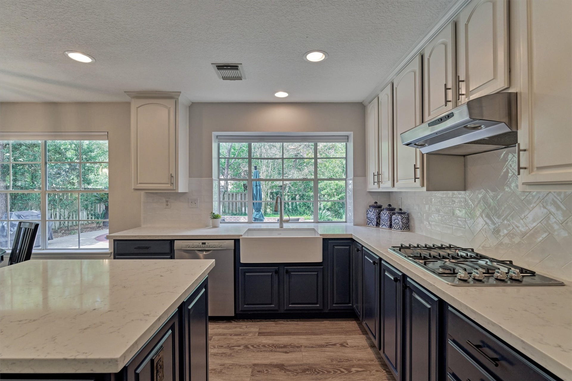 All the talking points in this picture-perfect kitchen, including an apron sink, gas cooktop, stainless appliances, walk-in pantry, and abundant prep space!