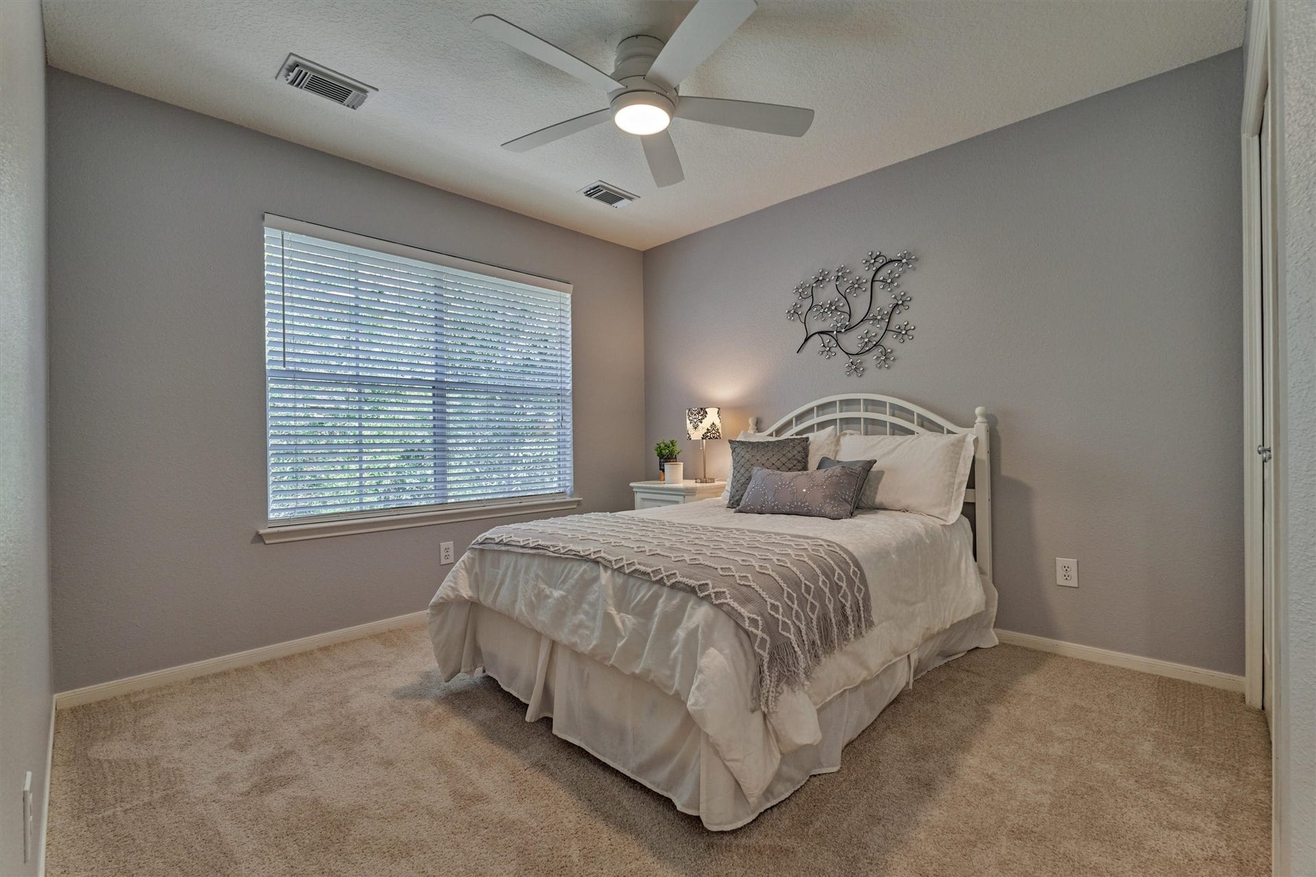 Secondary bedroom #1 features fresh carpeting, a ceiling fan, and a closet for added comfort and convenience!