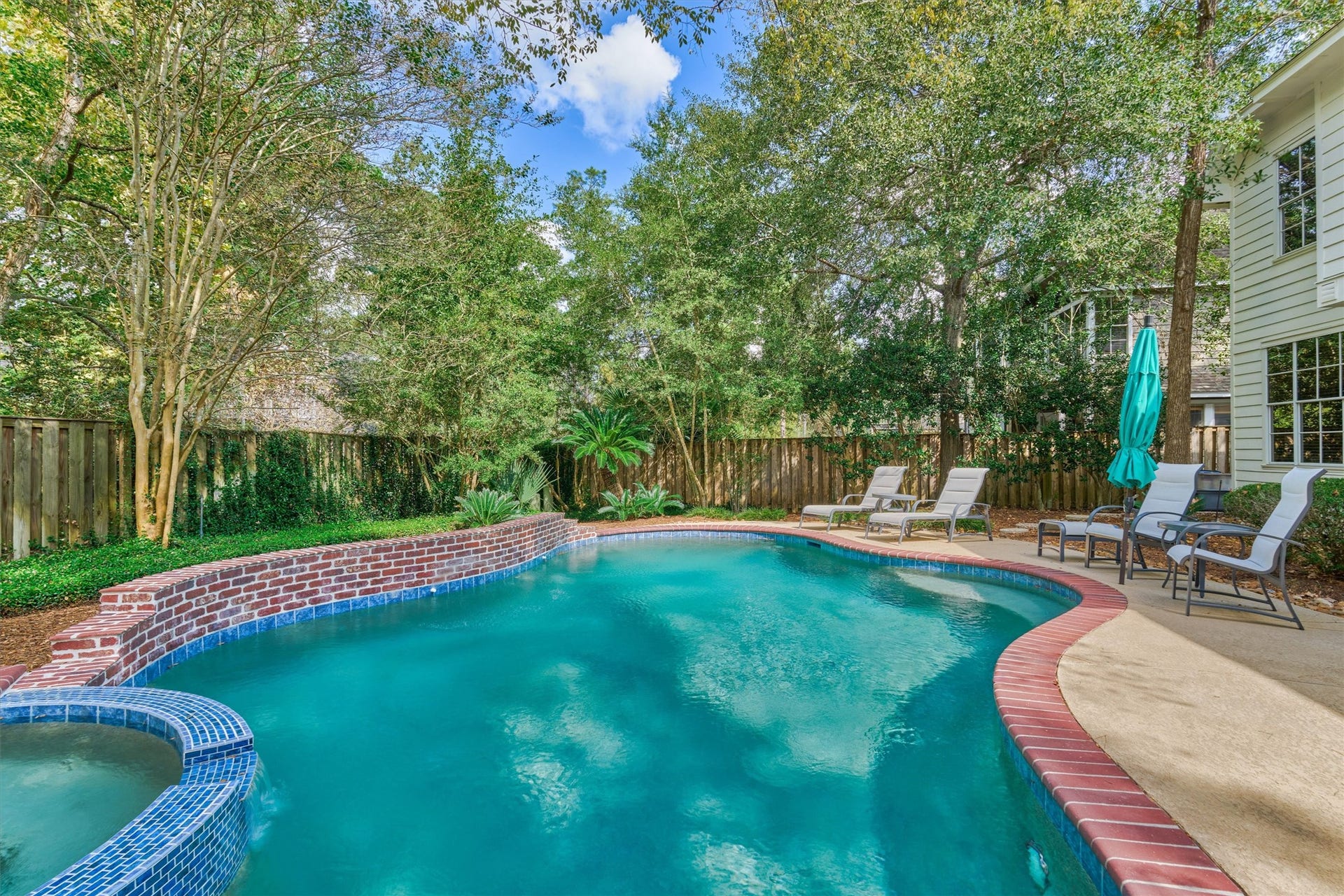 Enjoy the beauty of nature surrounding this serene backyard retreat.