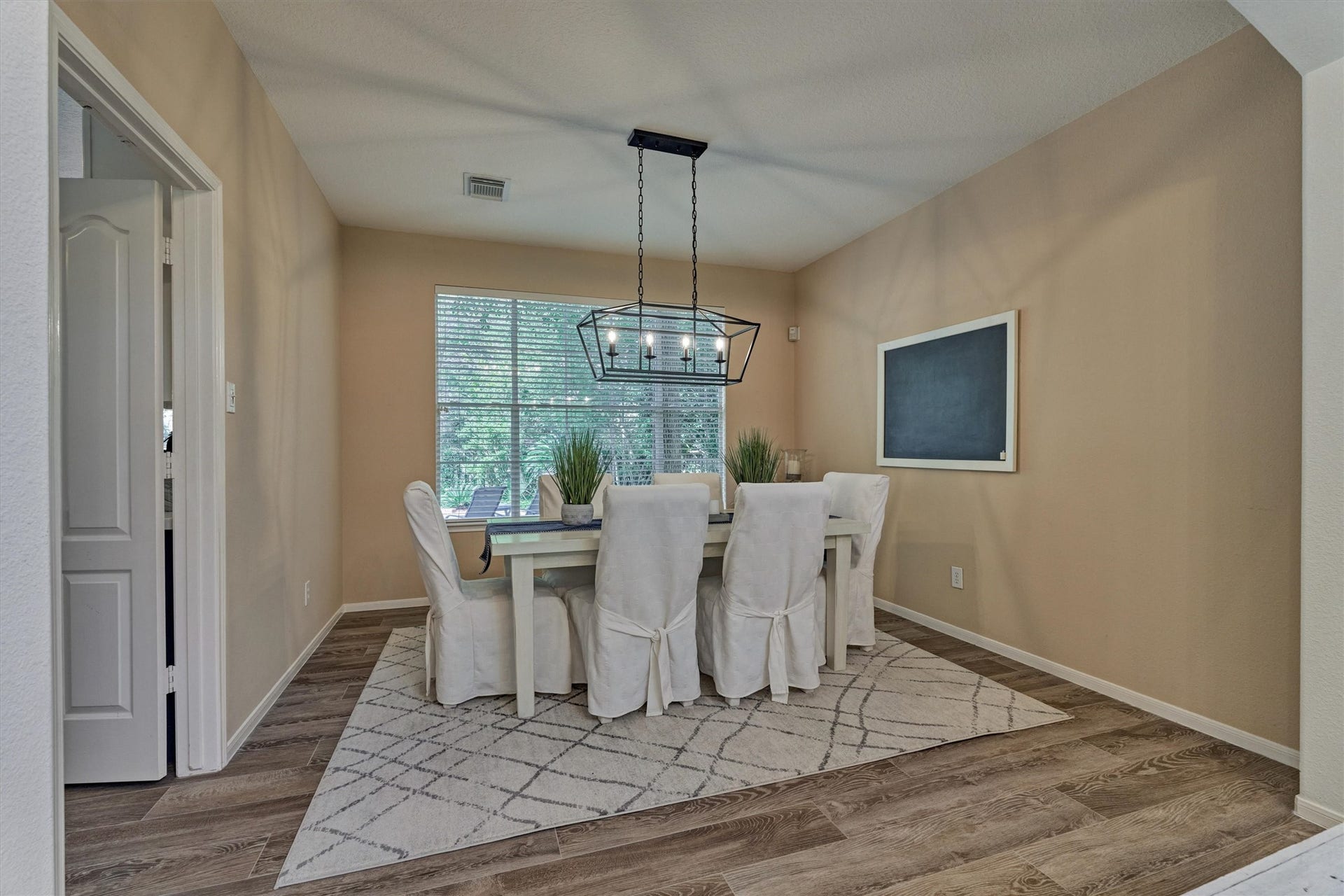 The spacious dining room features a convenient pass-through to the kitchen, making family meals and entertaining effortless!