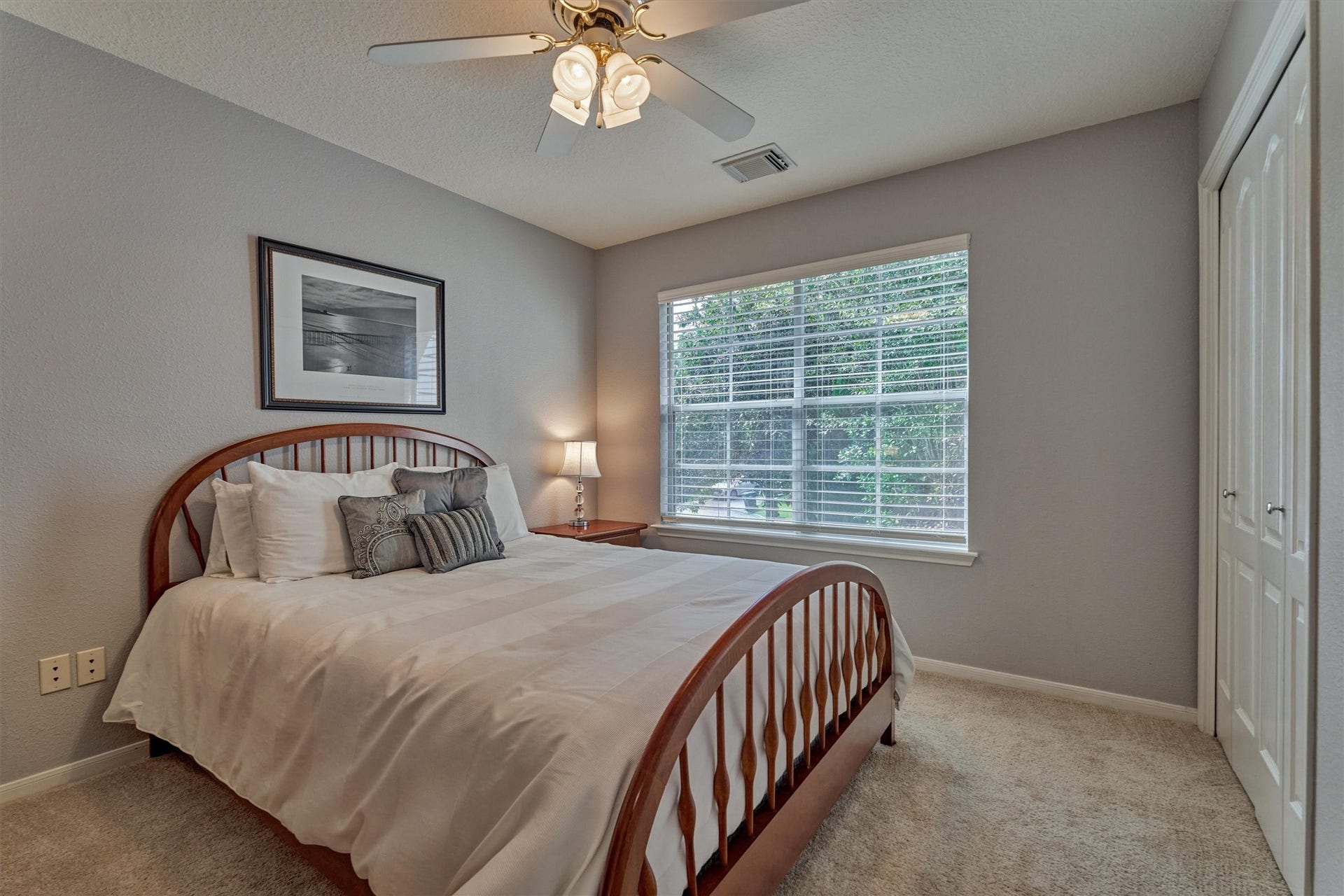 Secondary bedroom #2 features fresh carpeting, a ceiling fan, ample natural light, and a closet for added convenience!
