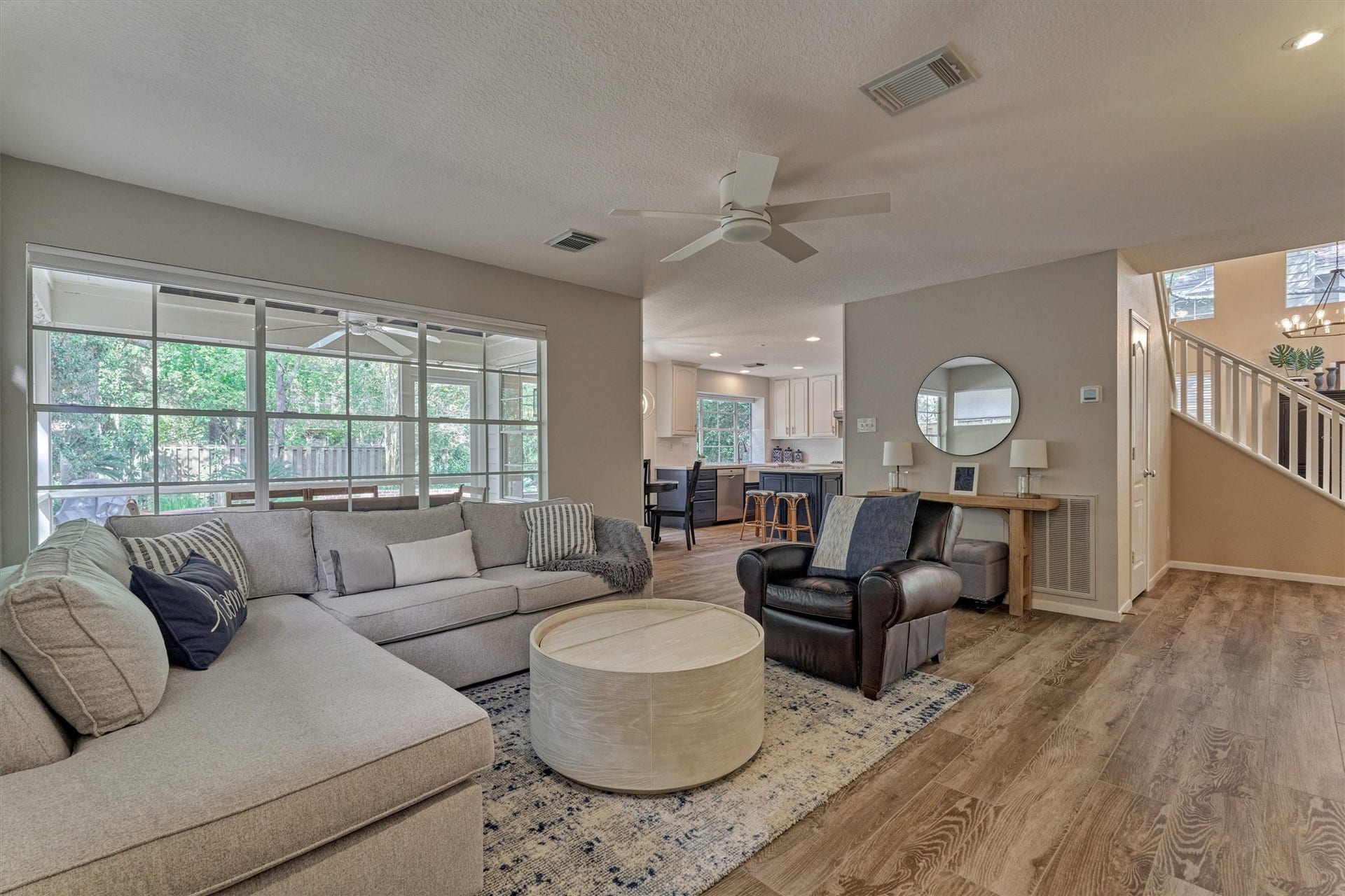 A wall of windows fills the space with abundant natural light while showcasing stunning views of the outdoor living areas!