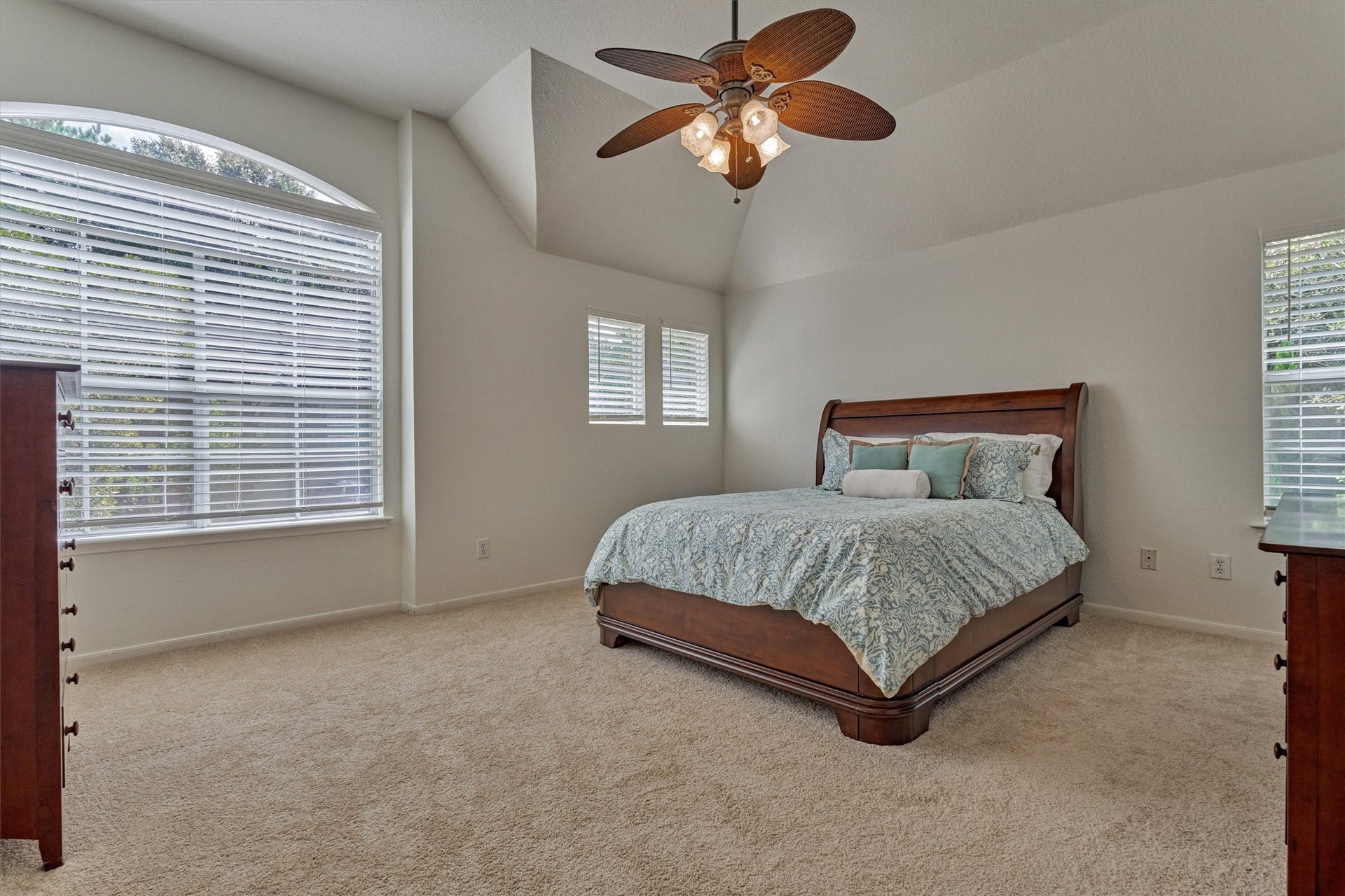 Spacious owner's suite features soaring ceilings, new carpeting, and airy windows, creating a bright and inviting retreat!
