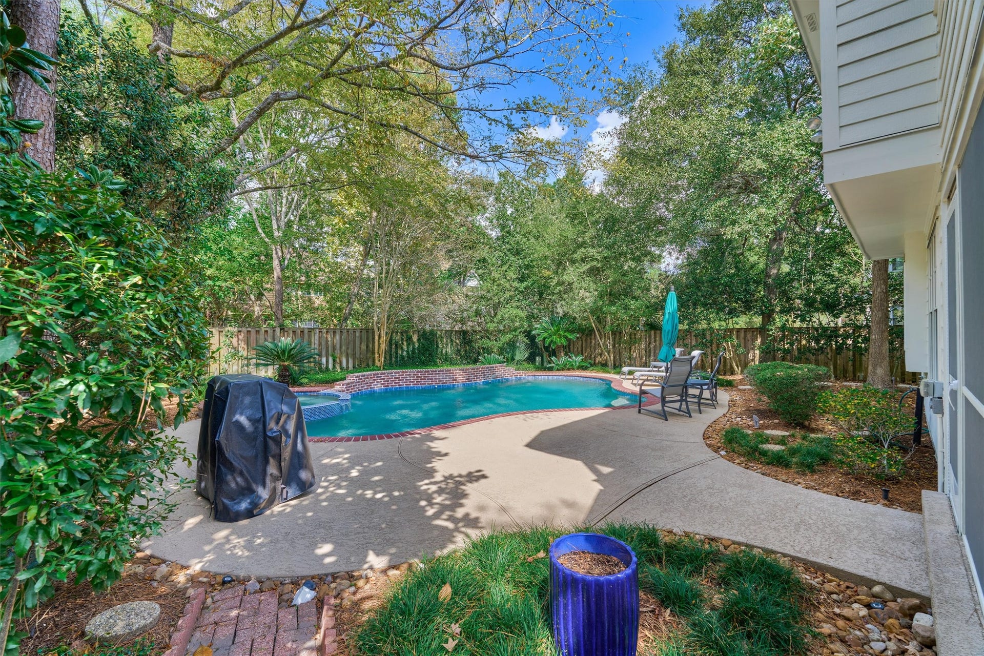 Privacy abounds in this serene backyard retreat, perfect for both peaceful relaxation and effortless entertaining!