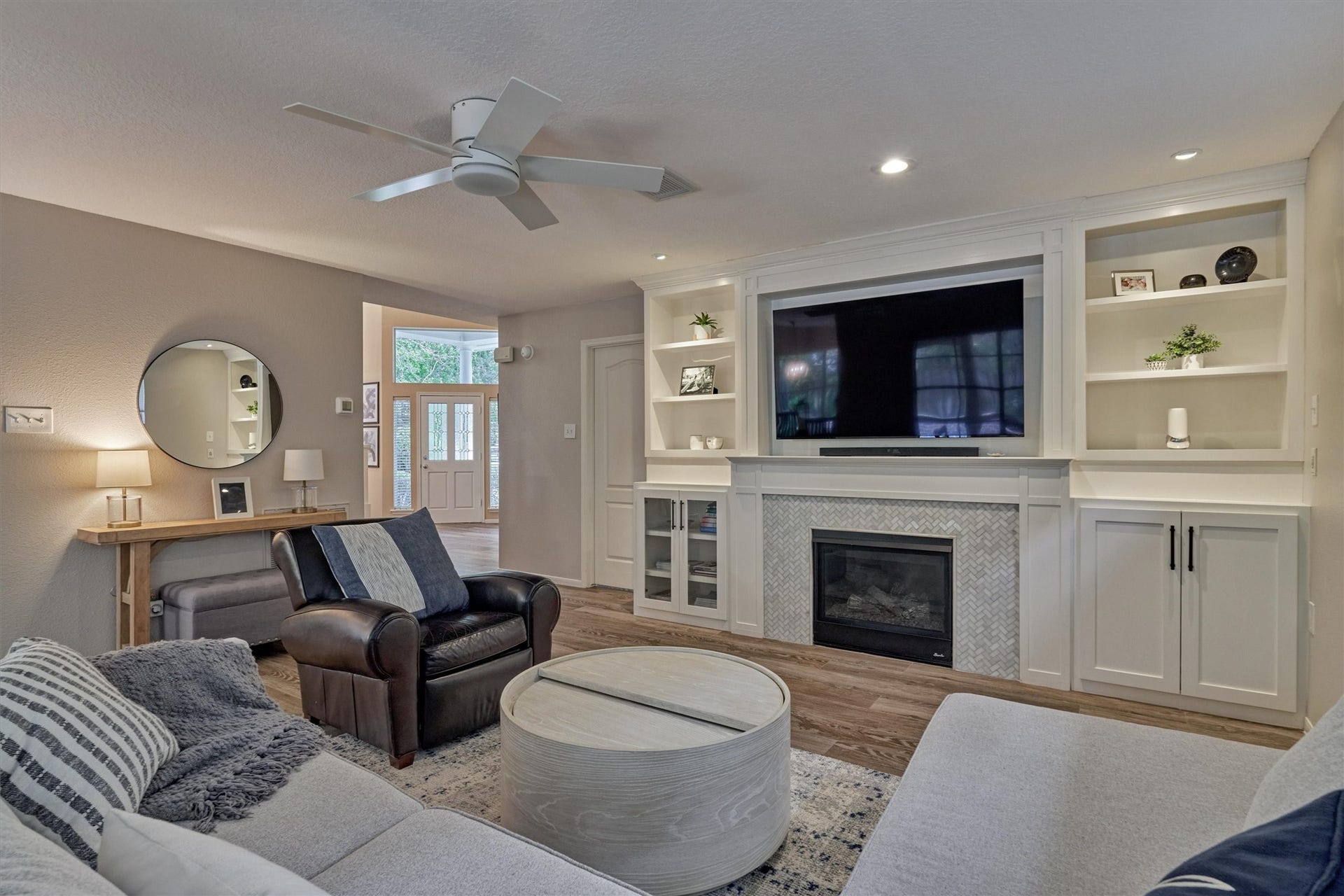 Views of the foyer and entryway from the den highlight the home's seamless flow and thoughtfully designed floor plan!