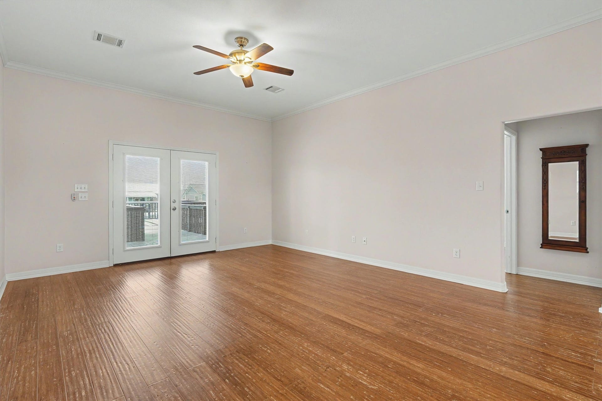 437 Pompano Street, Bayou Vista, TX 77563 Flooded with natural light, the living area boasts French doors that frame stunning water views, creating a serene and inviting atmosphere