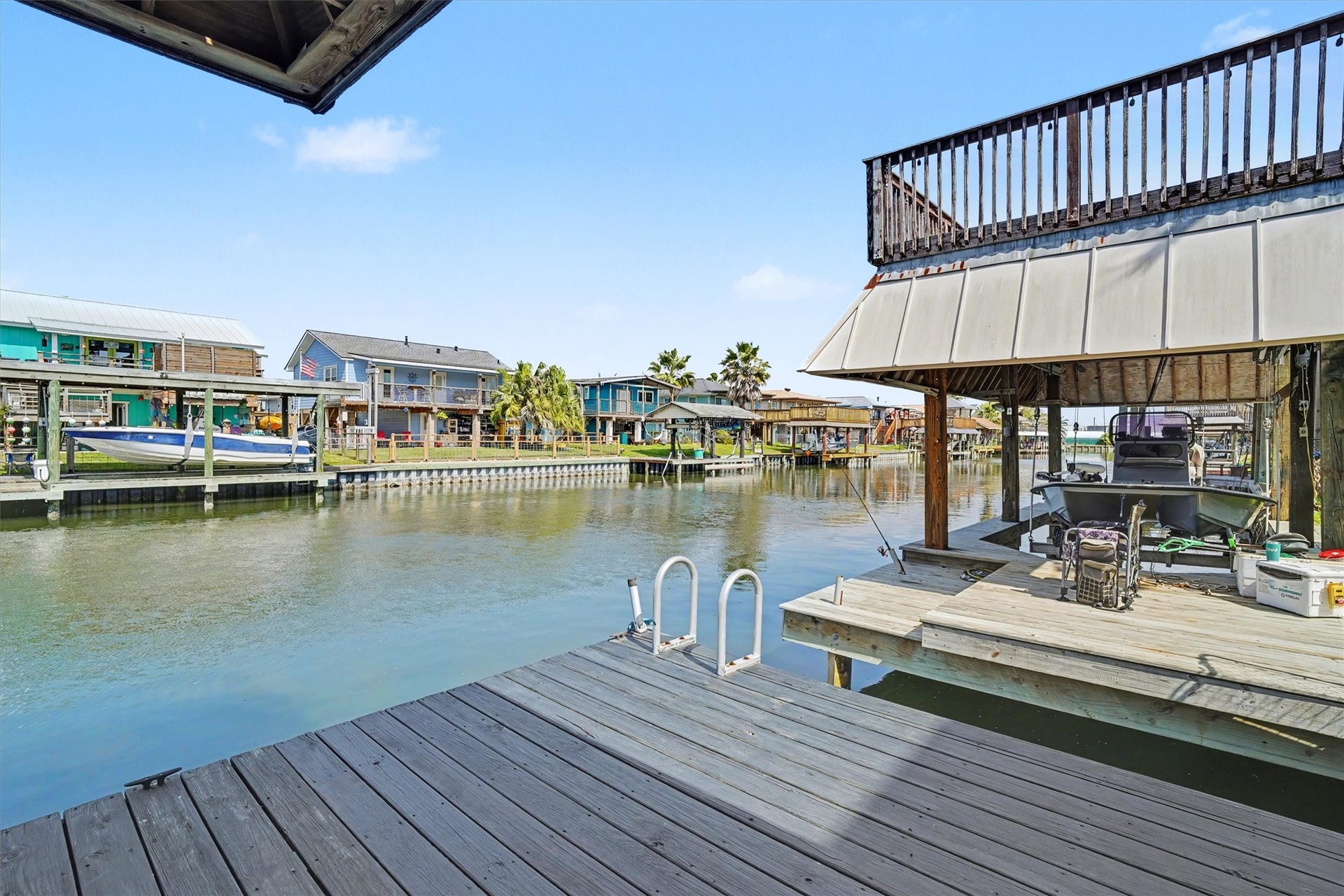 437 Pompano Street, Bayou Vista, TX 77563 Expansive dock with easy-access steps for slipping in and out of the wateryour personal gateway to relaxation and fun. Take in the tranquil views and feel the calm of the peaceful waters right from your very own dock
