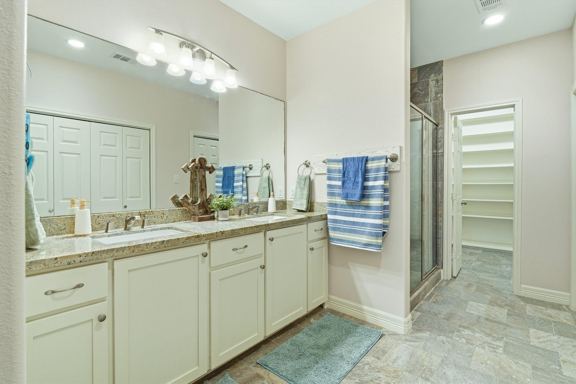 437 Pompano Street, Bayou Vista, TX 77563 Oversized primary bathroom with double sinks, white cabinets and plenty of storage