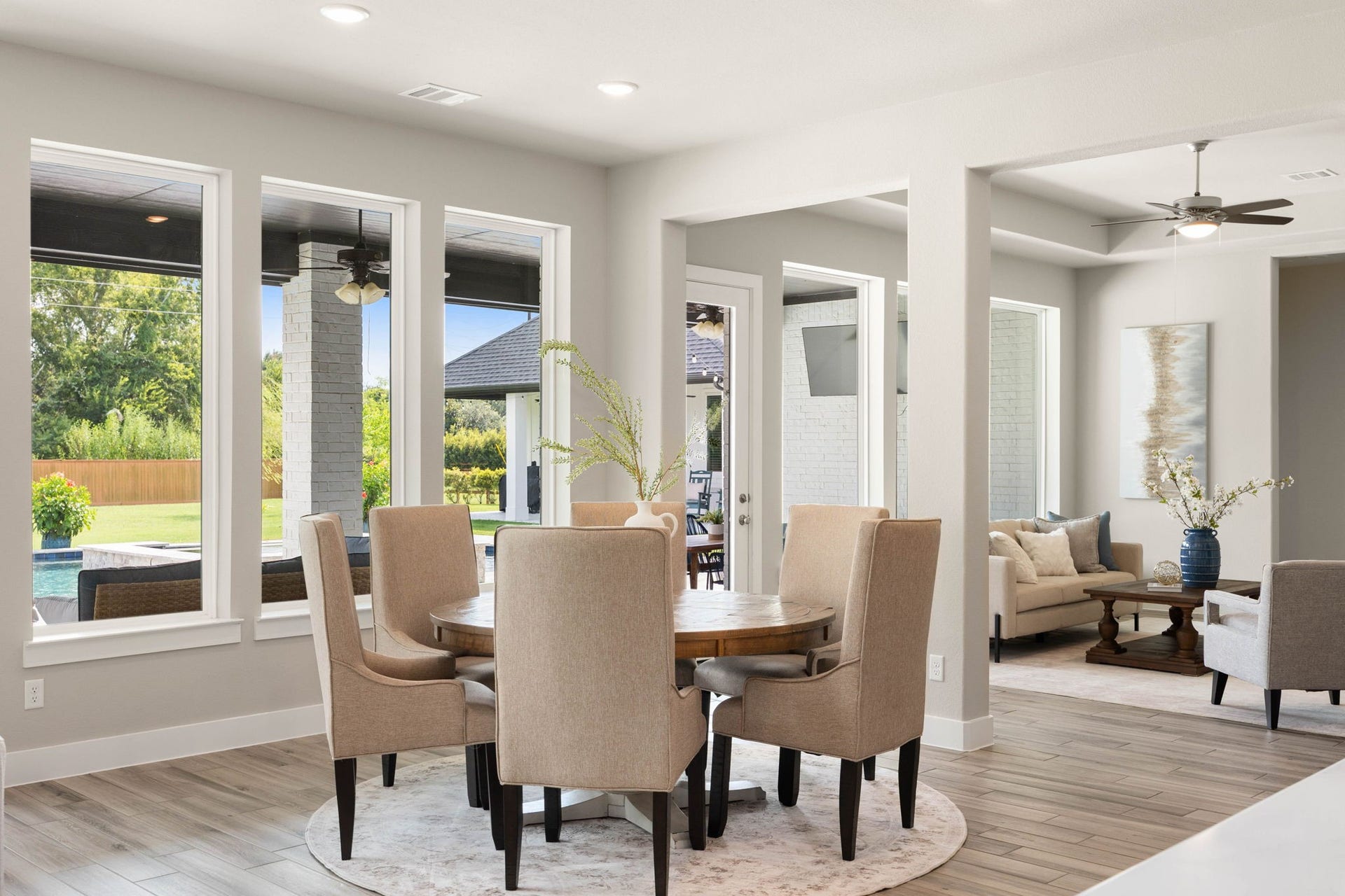 Bright breakfast area with oversized windows and lovely views of the backyard and outdoor living spaces.