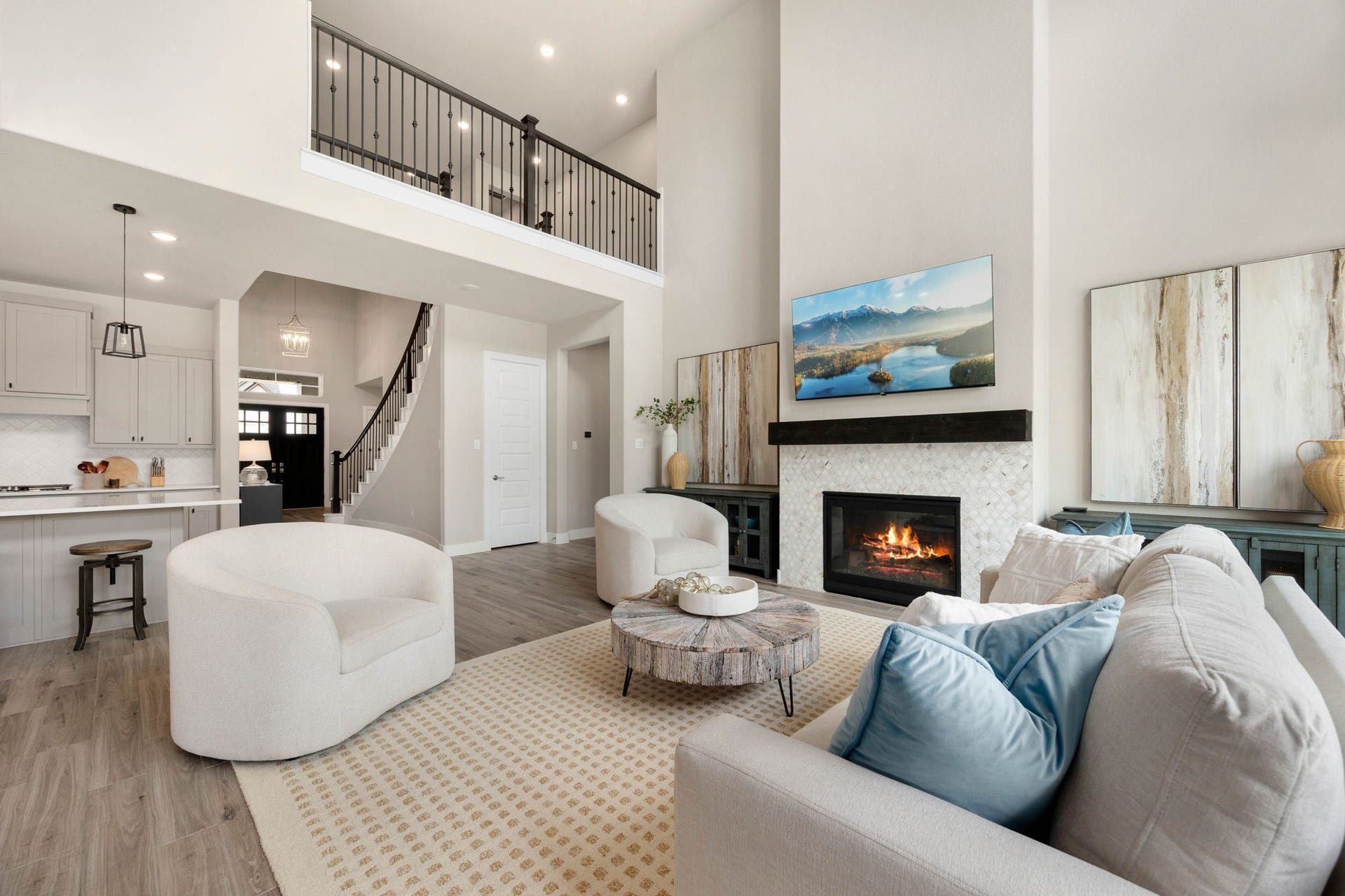 The dramatic two-story family room offers abundant natural light and a beautiful central fireplace.