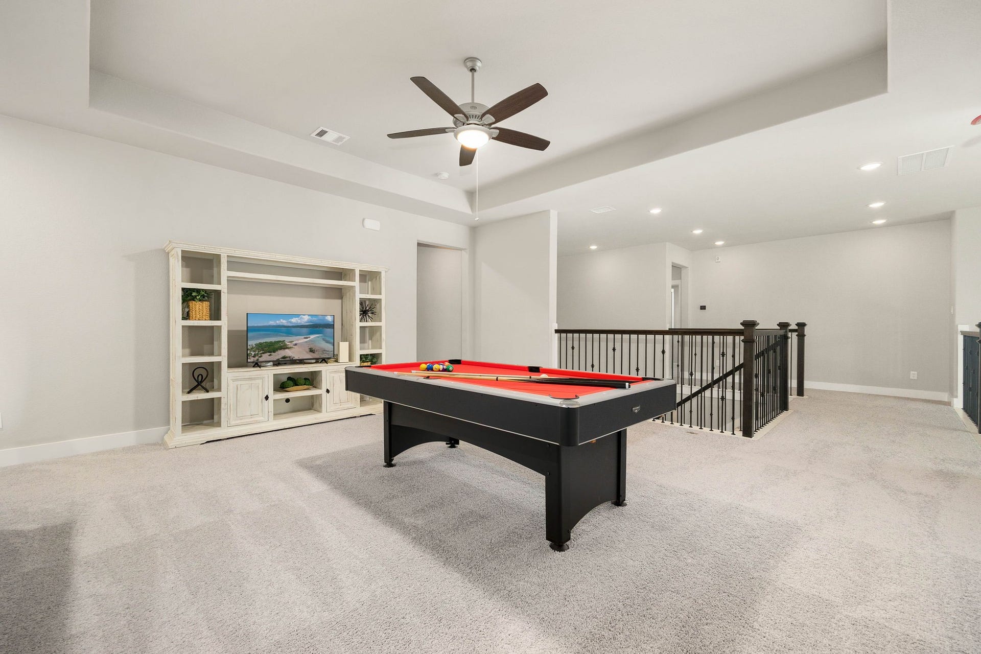 Generous upstairs game room offers plenty of space for a pool table, media setup and casual entertaining.