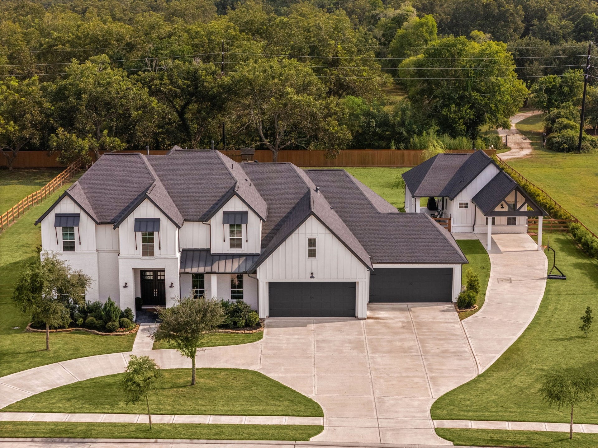 This modern farmhouse has it all...including curb appeal! Check out the circle drive and extra parking for the casita!
