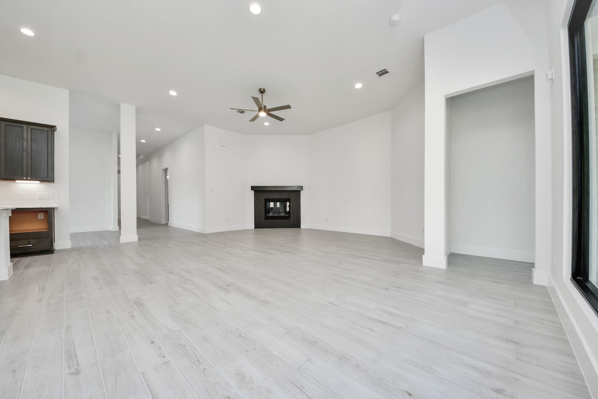 Gather the family and guests together in your lovely living room! Featuring soaring high ceilings, recessed lighting, ceiling fan, custom paint, gorgeous floors, and large windows that provide plenty of natural lighting throughout the day.