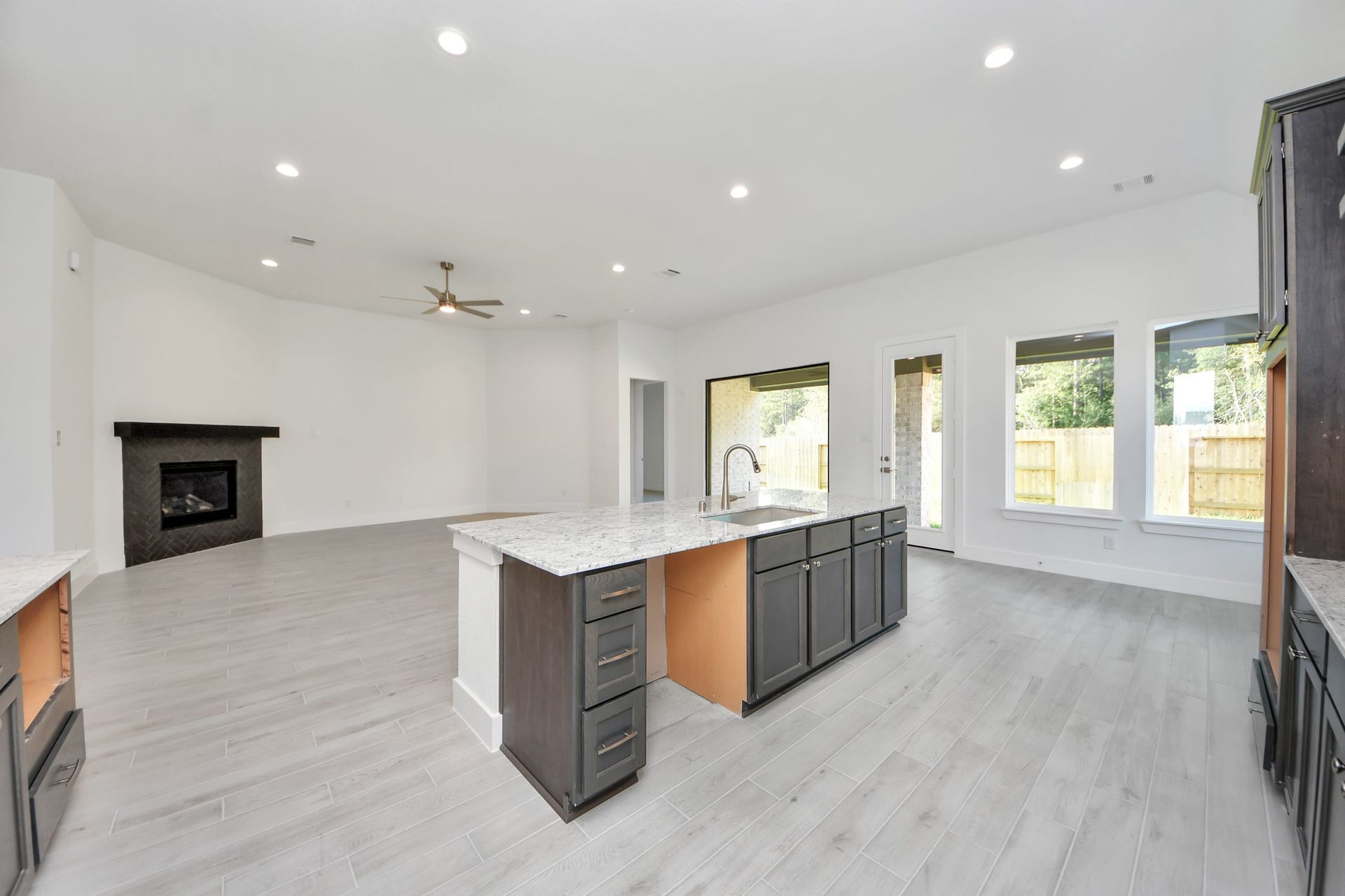Step into a dream realized with this generously spacious kitchen! A massive granite island takes center stage, complemented by high ceilings and soft-close cabinets. The granite countertops, stainless steel appliances, sleek tile backsplash, and recessed lighting complete the elegant design.