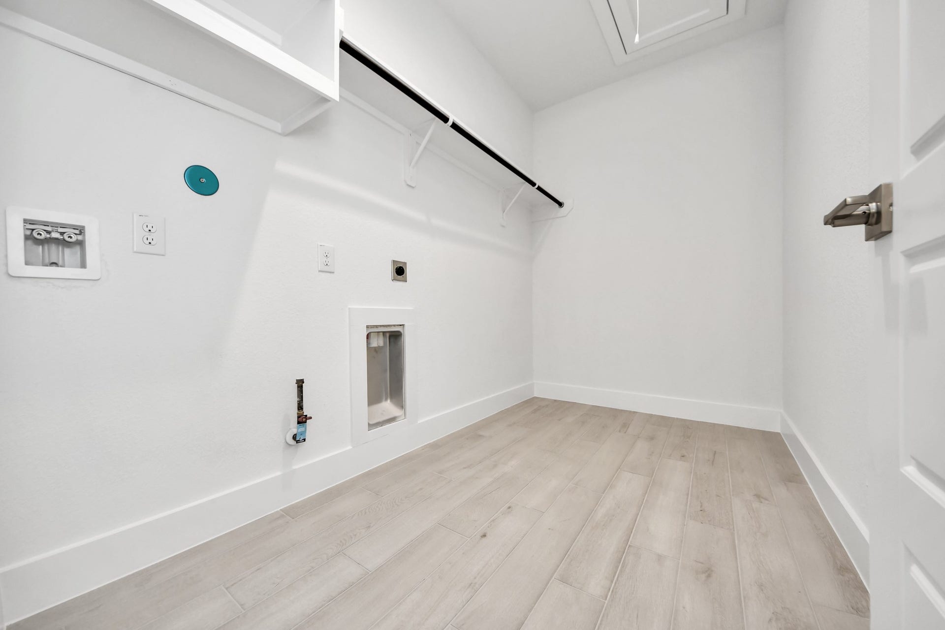A perfect blend of functionality and comfort. Capture the essence of easy living with a first-floor laundry room, thoughtfully equipped with shelving for effortless organization. Both electric and gas connections available.
