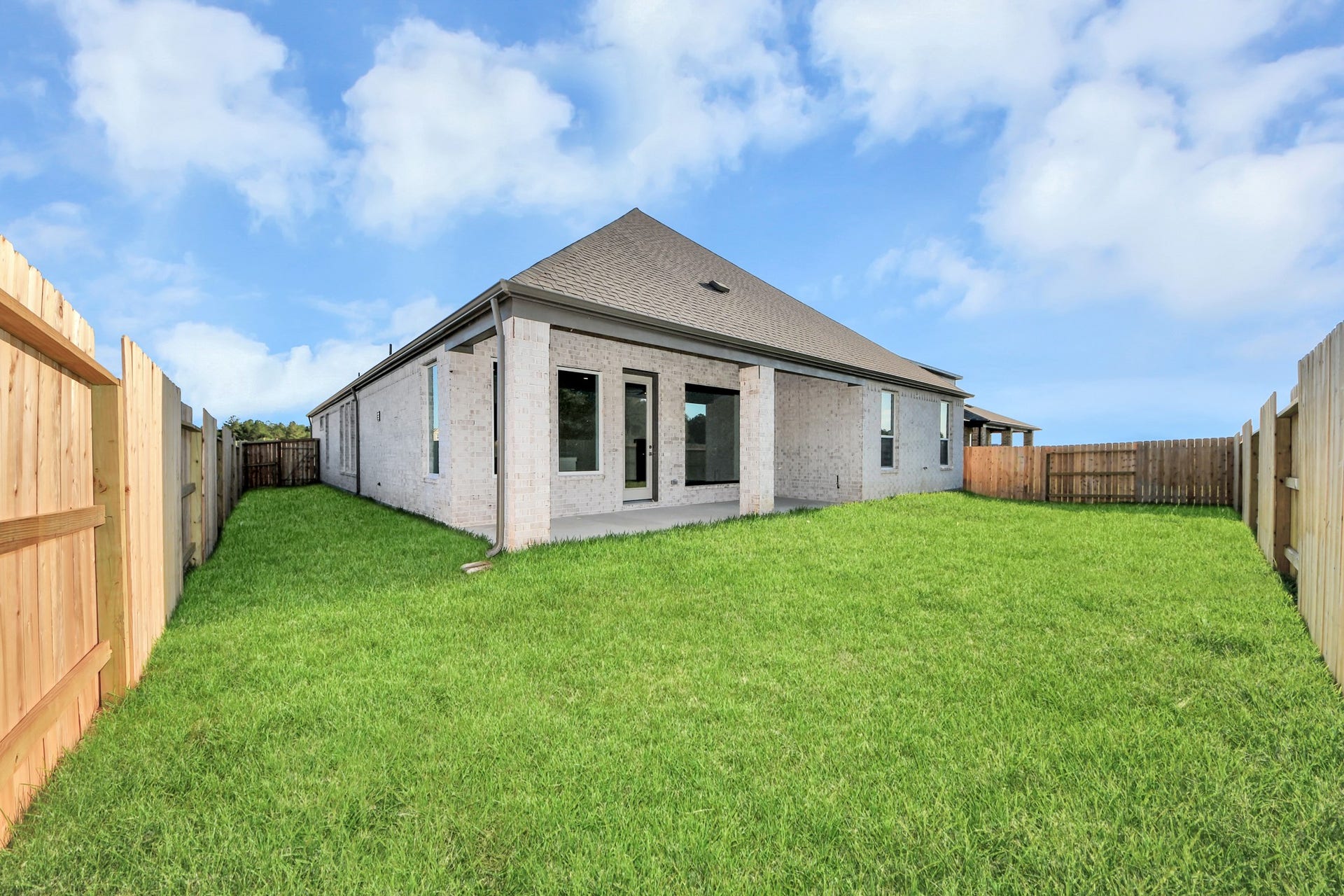 Come and see this spacious backyard with its beautiful covered patio. There is plenty of room for the kids to play and adults to relax. Perfect for your outdoor living space, patio furniture, bbq pit, and so much more. The possibilities are endless!