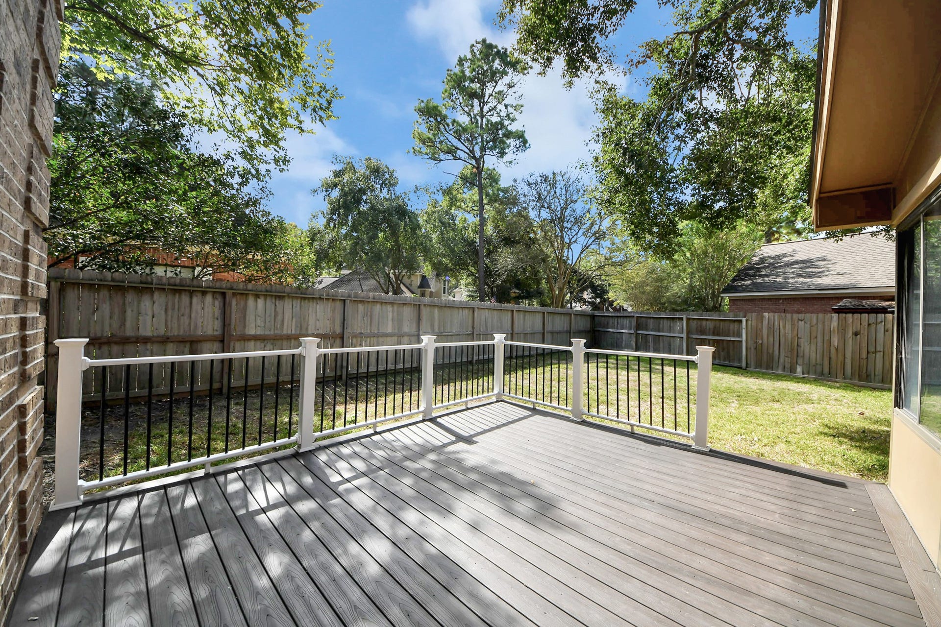 24 Hornsilver Place, The Woodlands, TX 77381 Backyard deck off the sunroom, perfect for outdoor relaxation, gathering, and grilling,