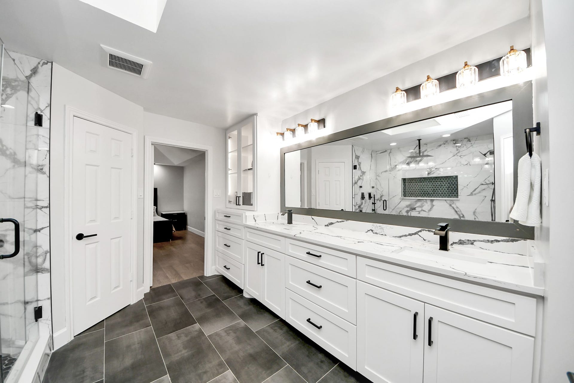 24 Hornsilver Place, The Woodlands, TX 77381 Grand vanity with dual sinks, plenty of counter space, and under-vanity storage.