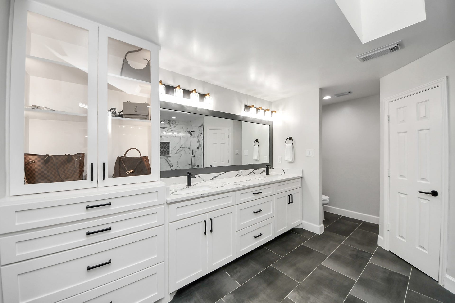 24 Hornsilver Place, The Woodlands, TX 77381 Custom wardrobe-style cabinetry with glass-front uppers.