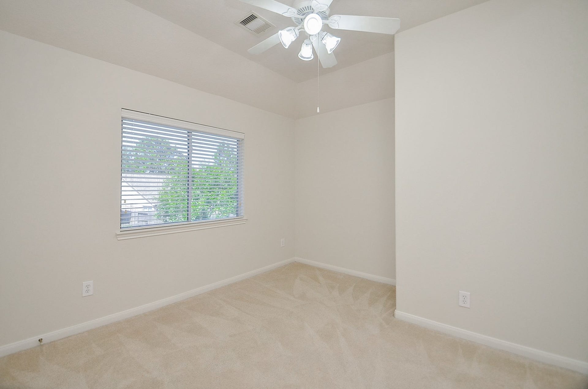4746 Autumn Orchard Lane, Katy, TX 77494 The second bedroom three offers a cozy retreat with abundant natural light and serene backyard views.