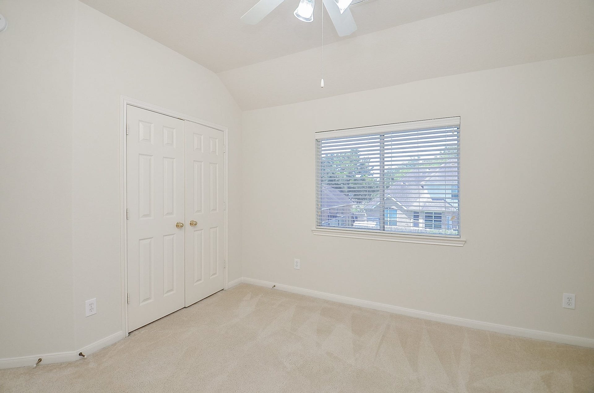 4746 Autumn Orchard Lane, Katy, TX 77494 The second bedroom three offers a cozy retreat with abundant natural light and serene backyard views.