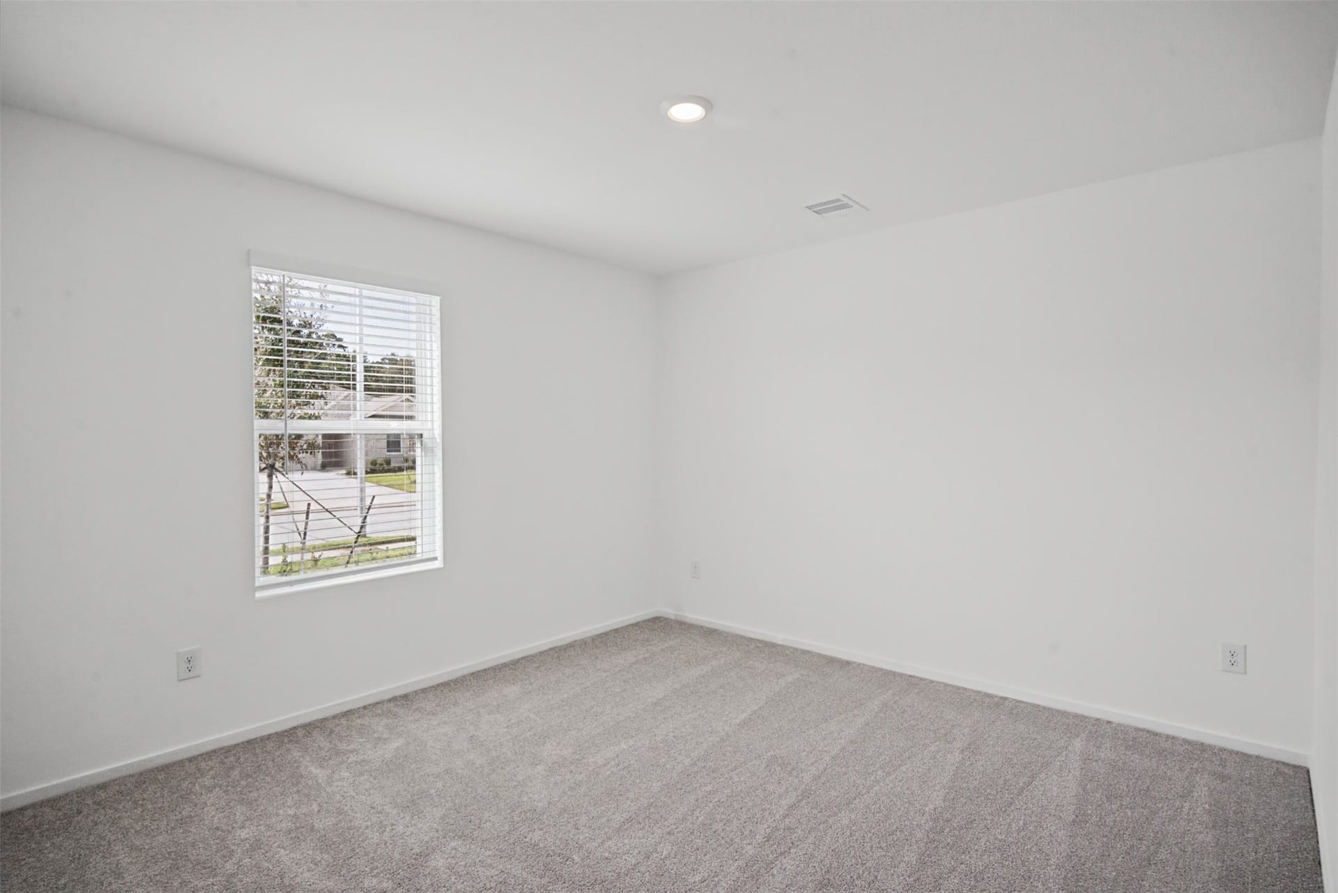 1718 Primrose Pointe Drive, Crosby, TX 77532 A bright, inviting bedroom with soft carpeting and natural lightan easy space to personalize as a comfortable bedroom, guest retreat, or home office.