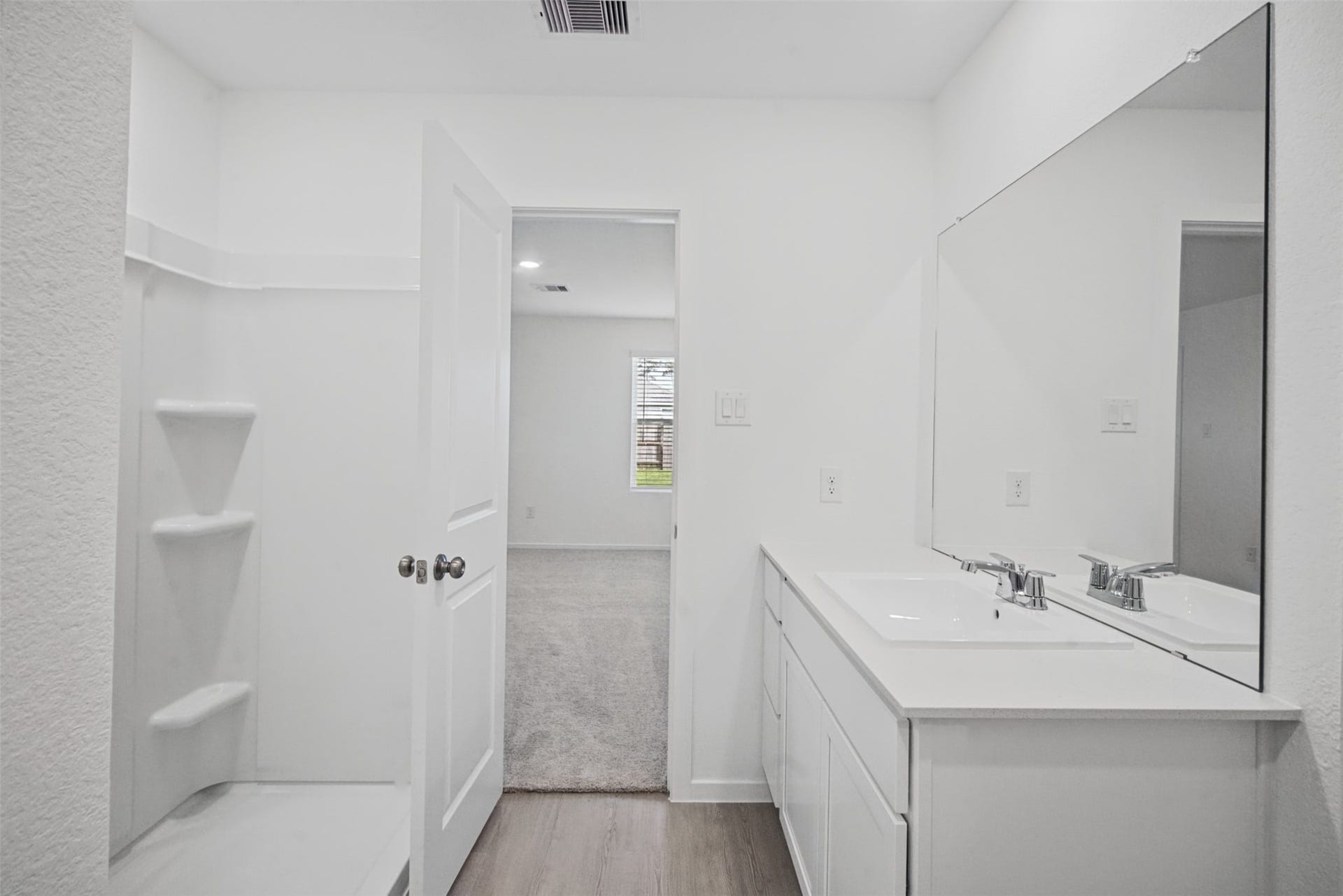 1718 Primrose Pointe Drive, Crosby, TX 77532 A clean, bright ensuite designed with everyday functionality in mind, keeping your private bedroom and bath spaces conveniently connected.