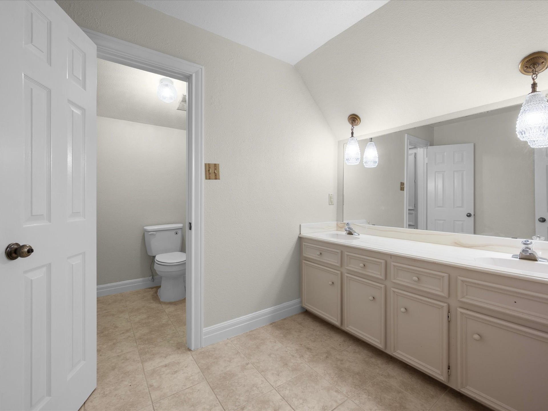 18006 Memorial Estates Drive, Spring, TX 77379 The upstairs full bath has a long vanity, with the toilet and tub in a separate room.