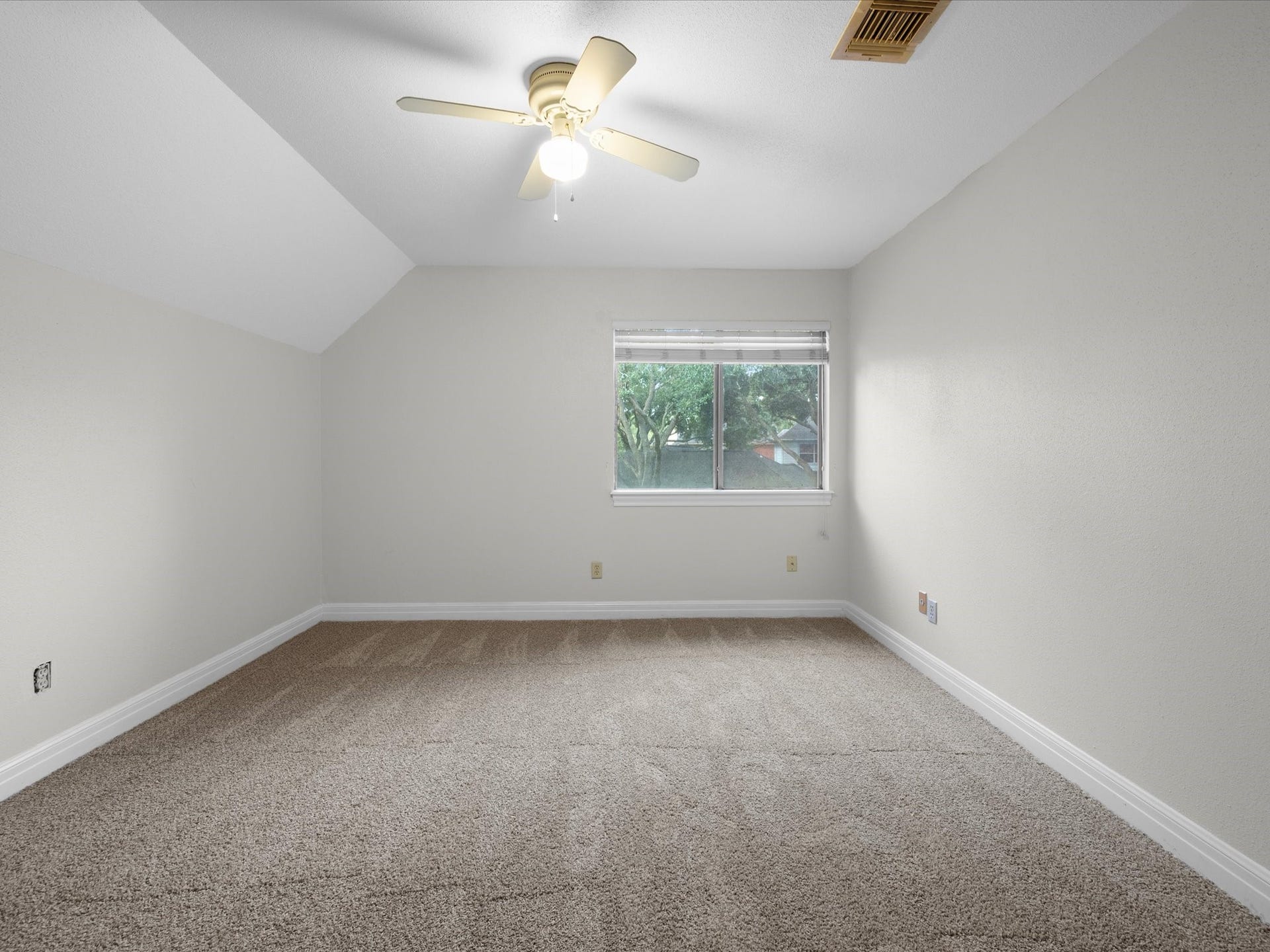 18006 Memorial Estates Drive, Spring, TX 77379 Another upstairs bedroom, with a ceiling fan and a window to the front.