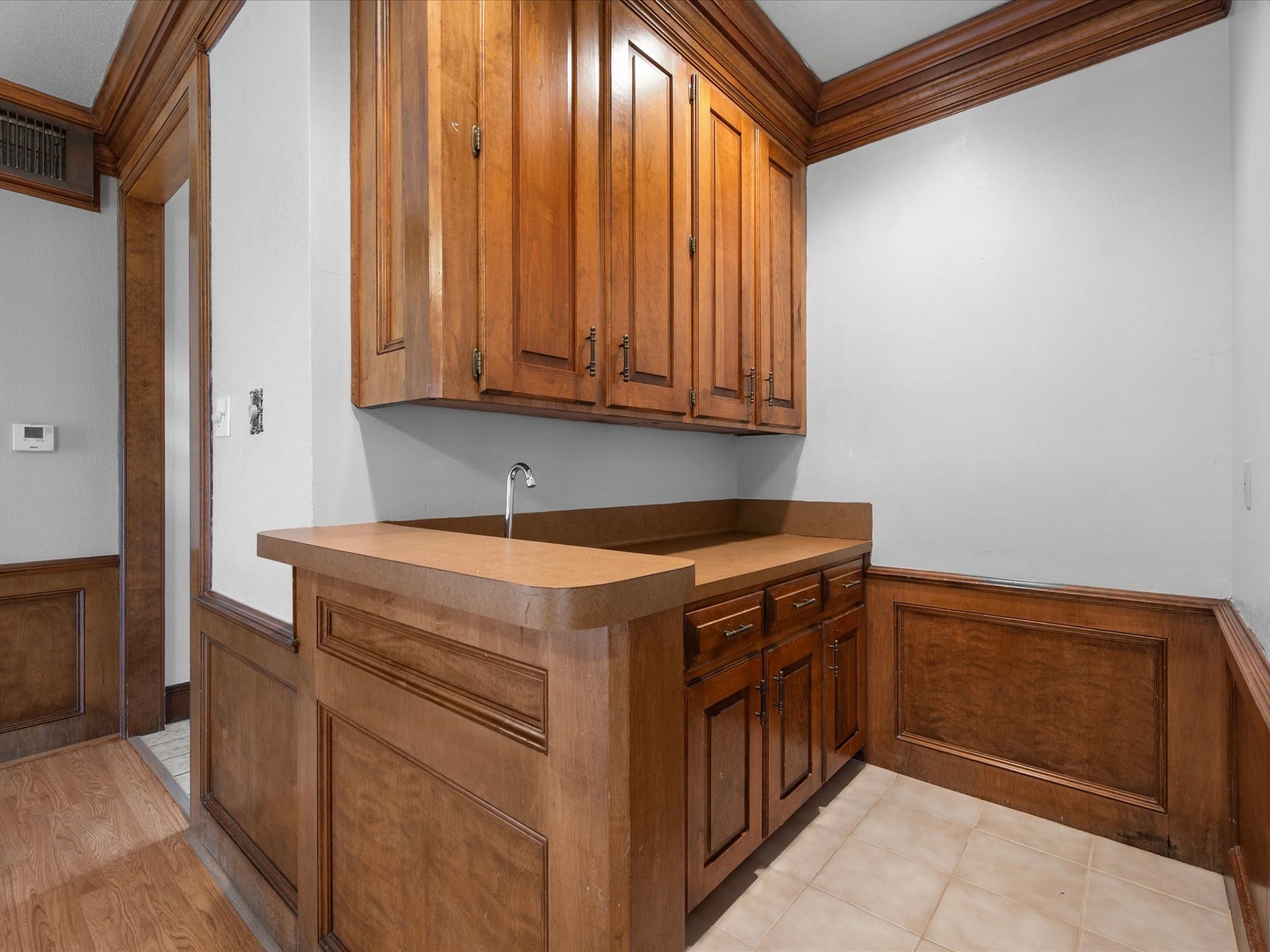 18006 Memorial Estates Drive, Spring, TX 77379 The wet bar has a sink and wood cabinets, right off the living room. It's an easy spot to set up drinks.
