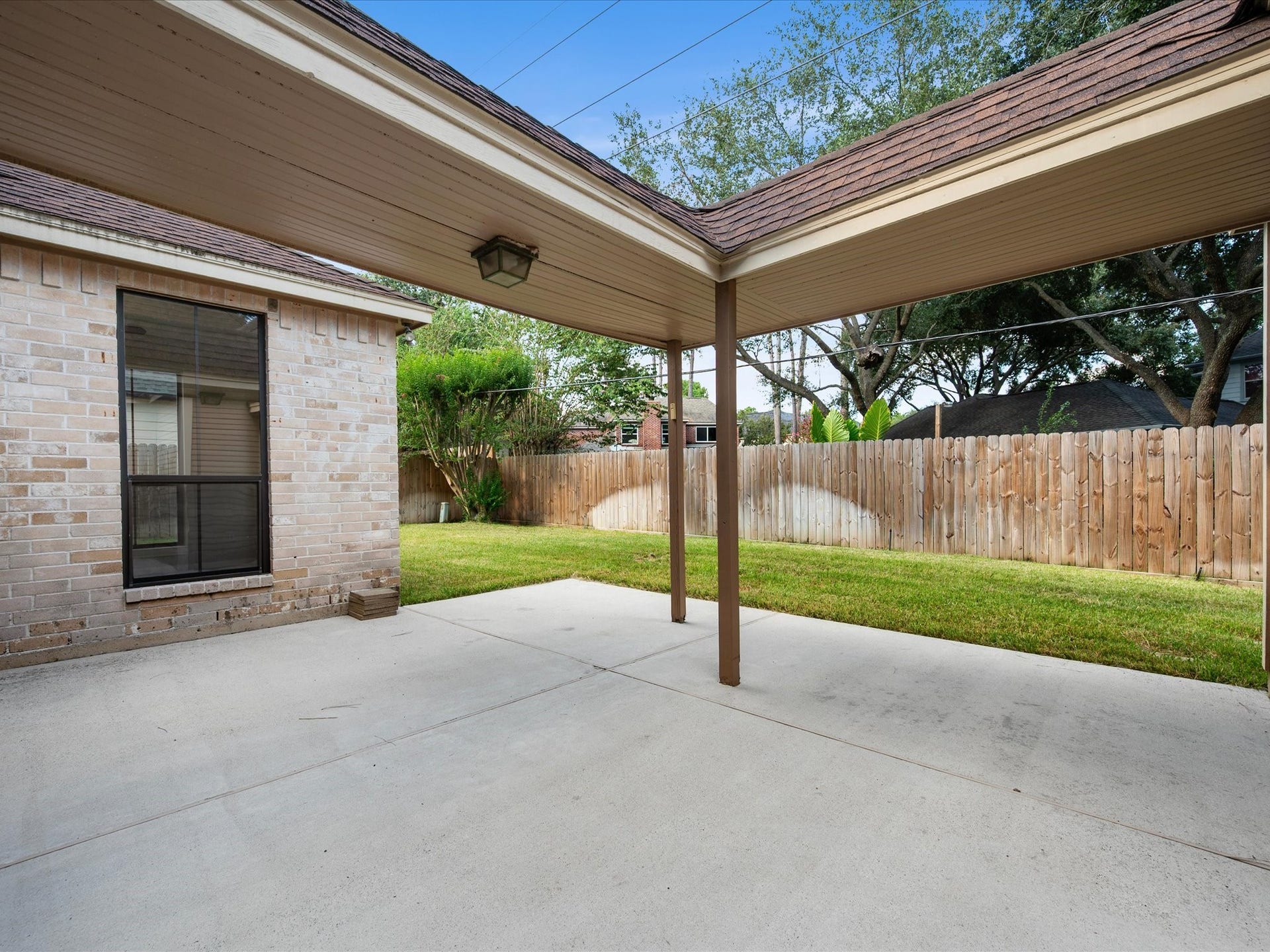 18006 Memorial Estates Drive, Spring, TX 77379 The covered back patio looks out over the fenced backyard.