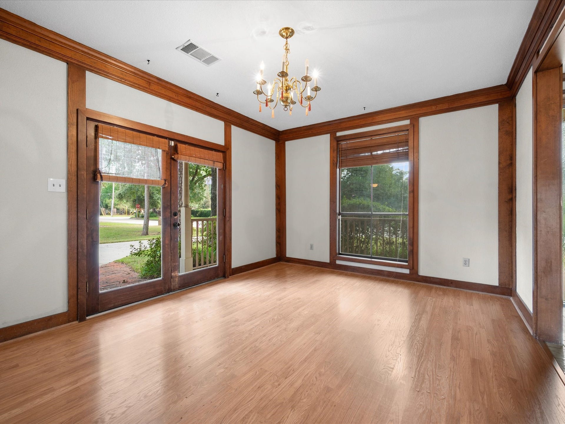 18006 Memorial Estates Drive, Spring, TX 77379 The dining room has a chandelier and French doors out to the front porch, with wood trim all the way around.