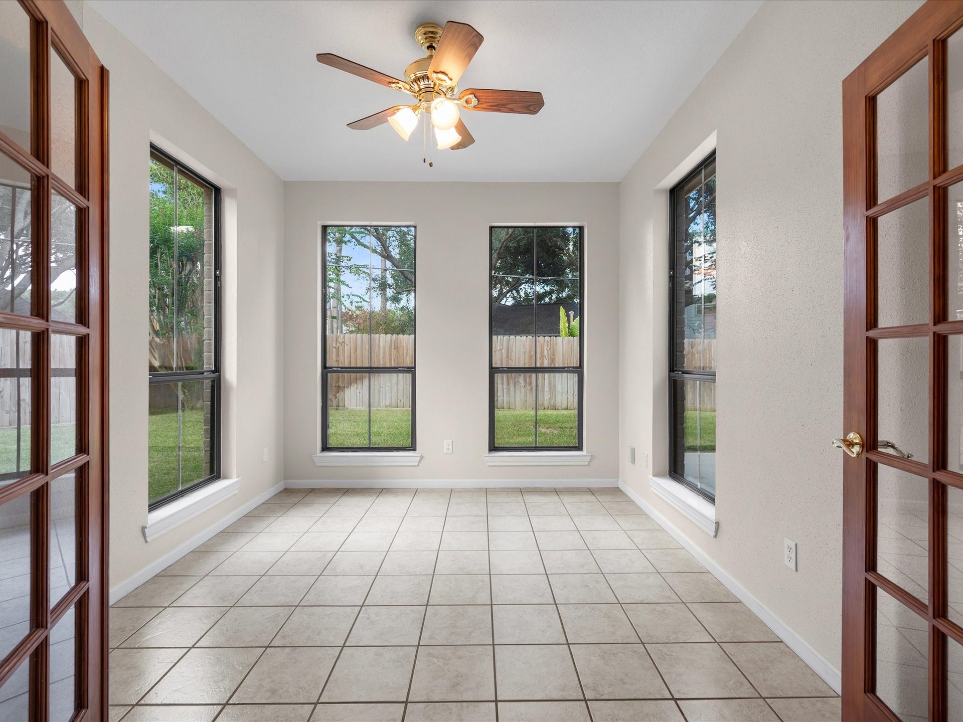 18006 Memorial Estates Drive, Spring, TX 77379 The home office has French doors that close, a ceiling fan, and windows looking out on the backyard.