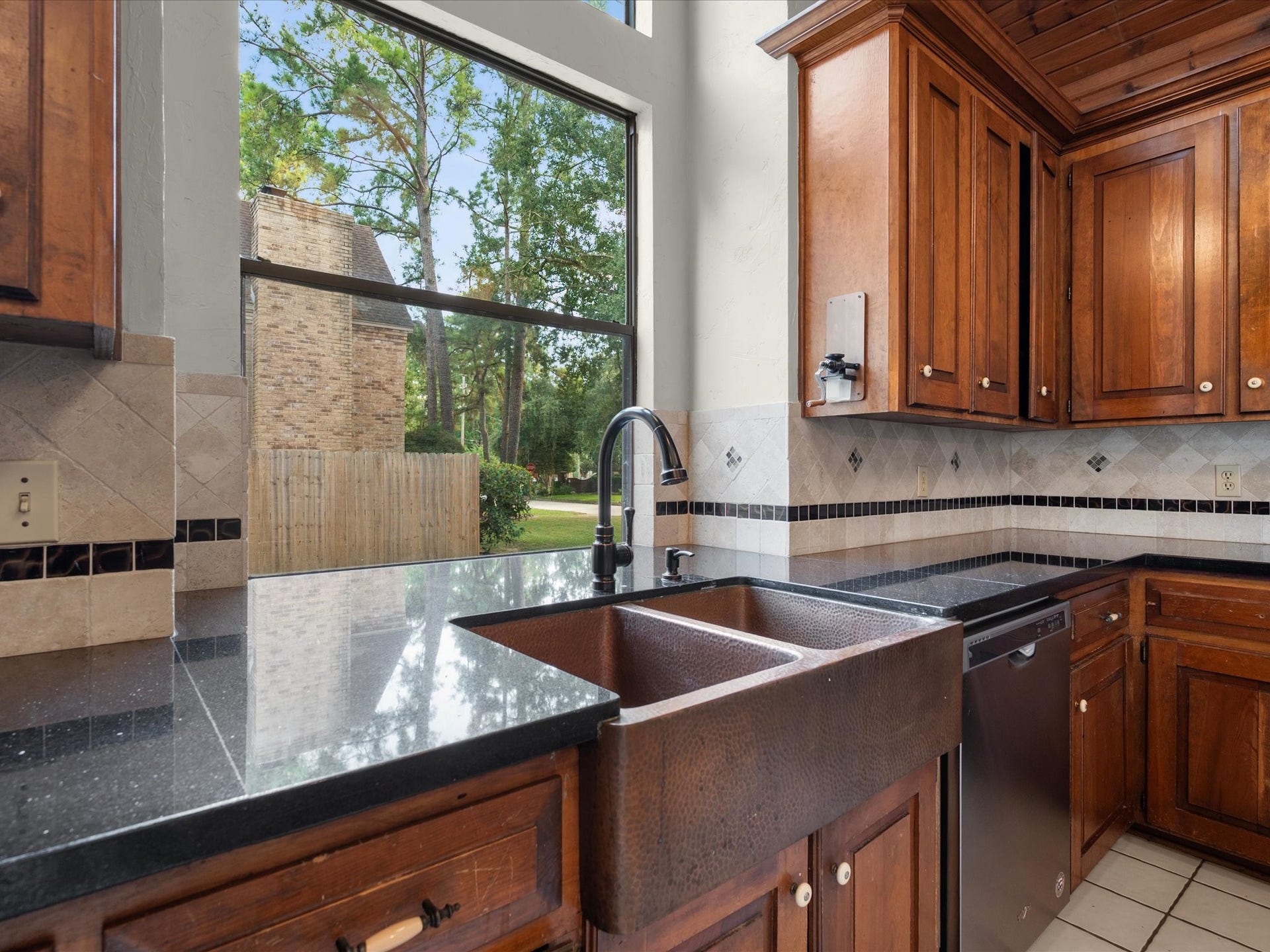 18006 Memorial Estates Drive, Spring, TX 77379 There's a deep double sink under a big window, so you can see the backyard while you do dishes.