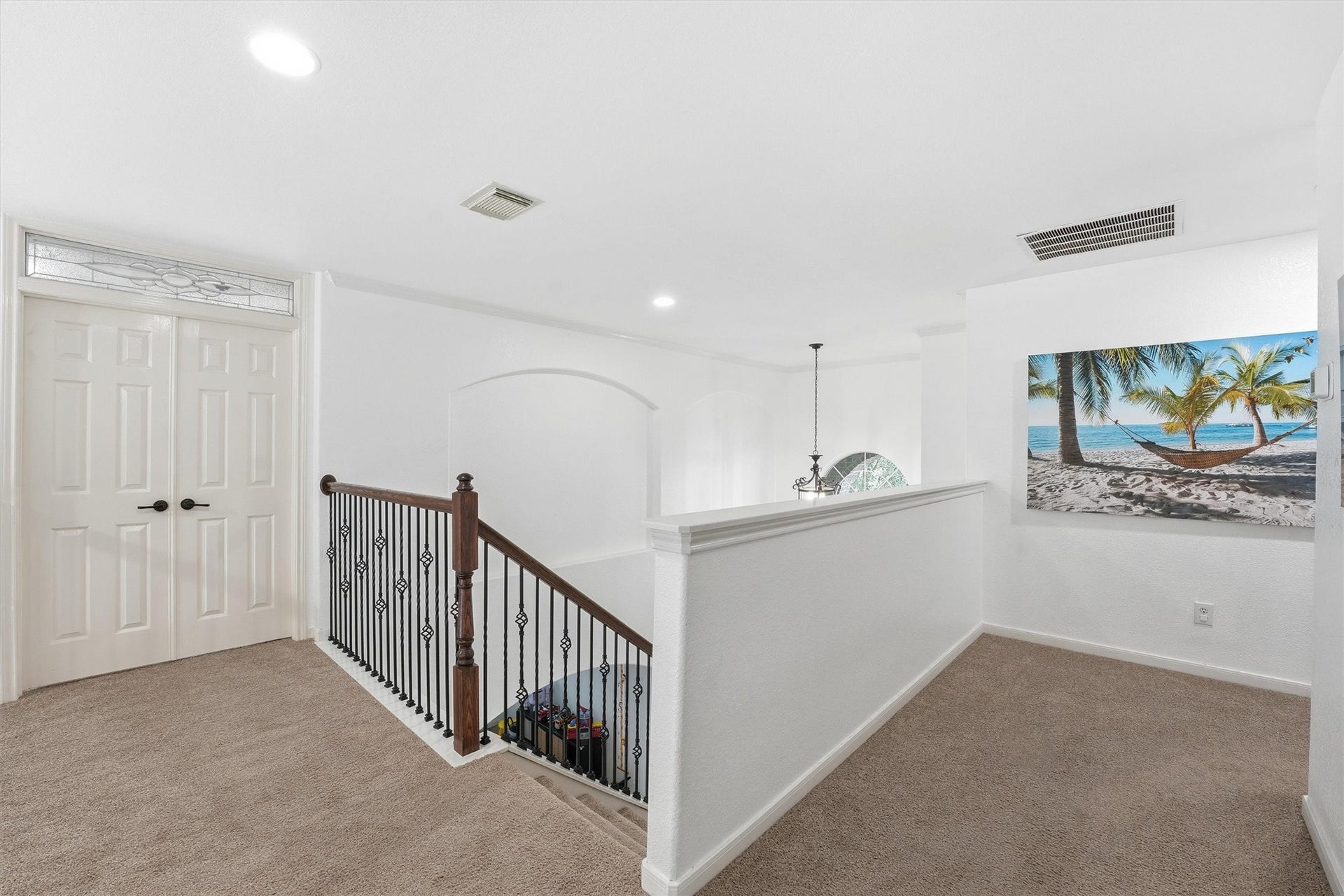 Bright dining area with large windows and a glass door leading to a patio and pool. Features a simple table setup on tiled flooring, offering a cozy, inviting atmosphere.