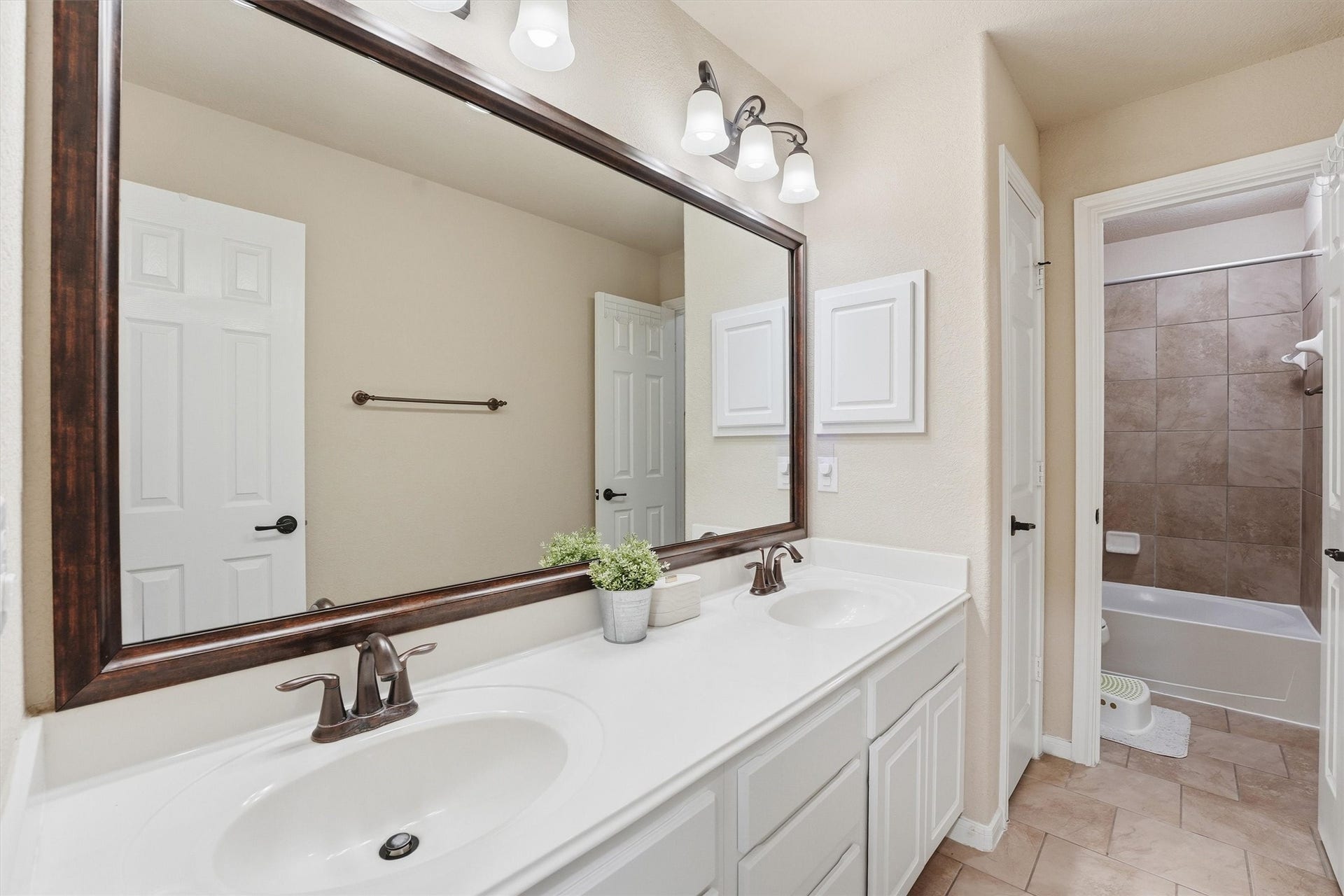 This room is a bright, versatile space ideal for a home gym, featuring neutral walls, carpet flooring, a ceiling fan, and natural light from two windows.
