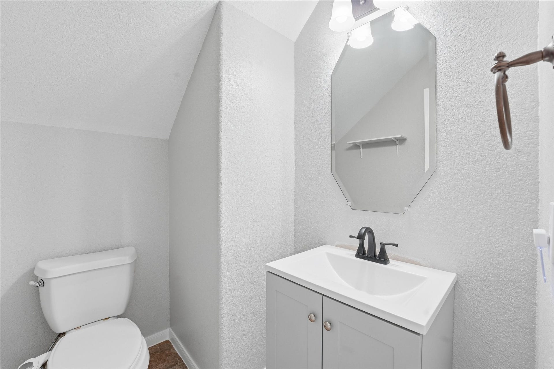 Bright playroom with large window, tiled floors, and ample storage. Features include a play kitchen, toy bins, and a playful wall decor. Ideal for children's activities.