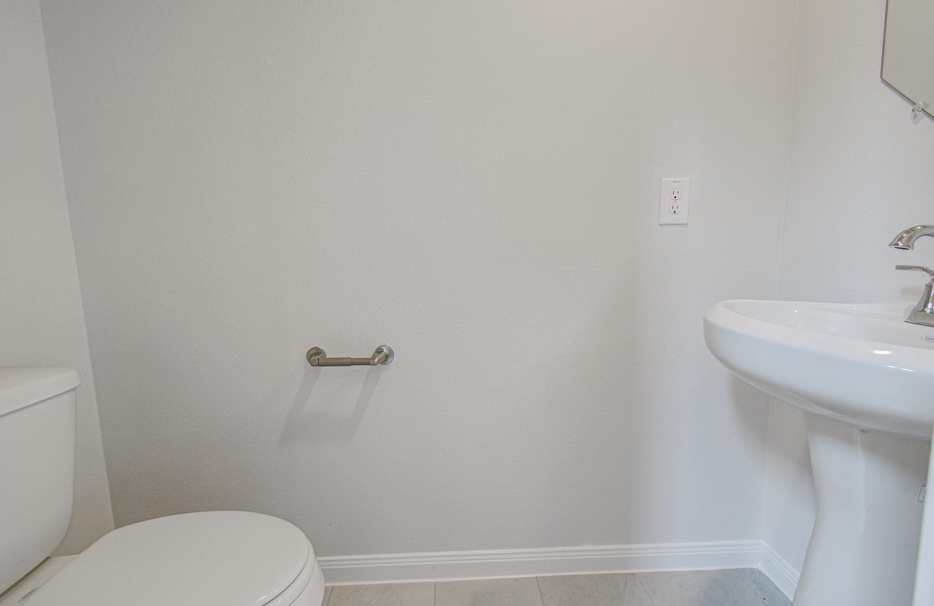 14210 Aston Pine Drive, Houston, TX 77032 Bright and clean half-bath located downstairs featuring a pedestal sink and modern fixtures. Please Note this is a different home/floorplan in the community.