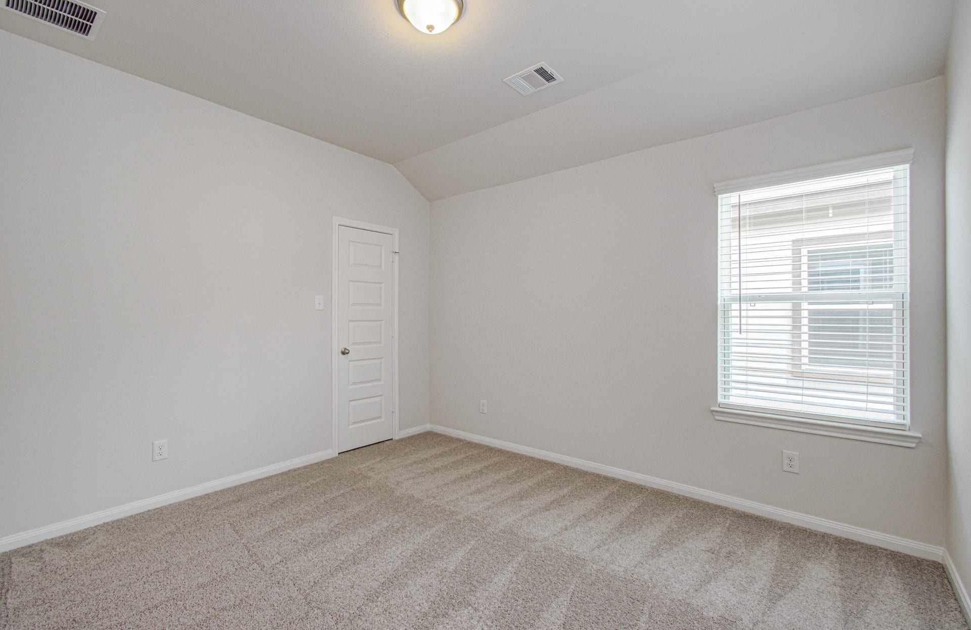 14210 Aston Pine Drive, Houston, TX 77032 Bright, cozy fourth room with soft carpet flooring, neutral walls, and ample natural light from a large window. Please Note this is a different home/floorplan in the community.