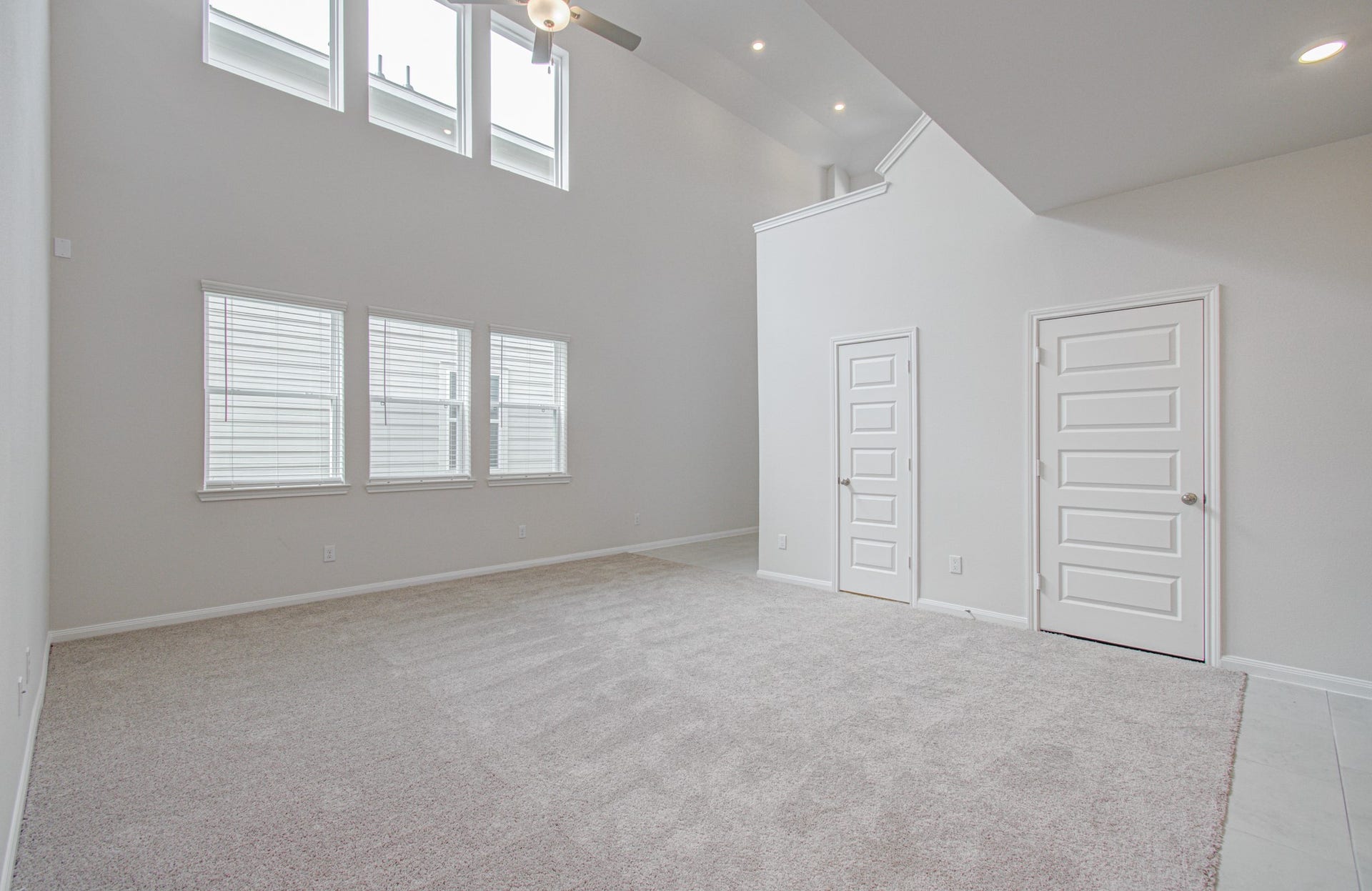 14210 Aston Pine Drive, Houston, TX 77032 Spacious living area with high ceilings, abundant natural light from large windows, and modern finishes for a bright, airy ambiance. Please Note this is a different home/floorplan in the community.