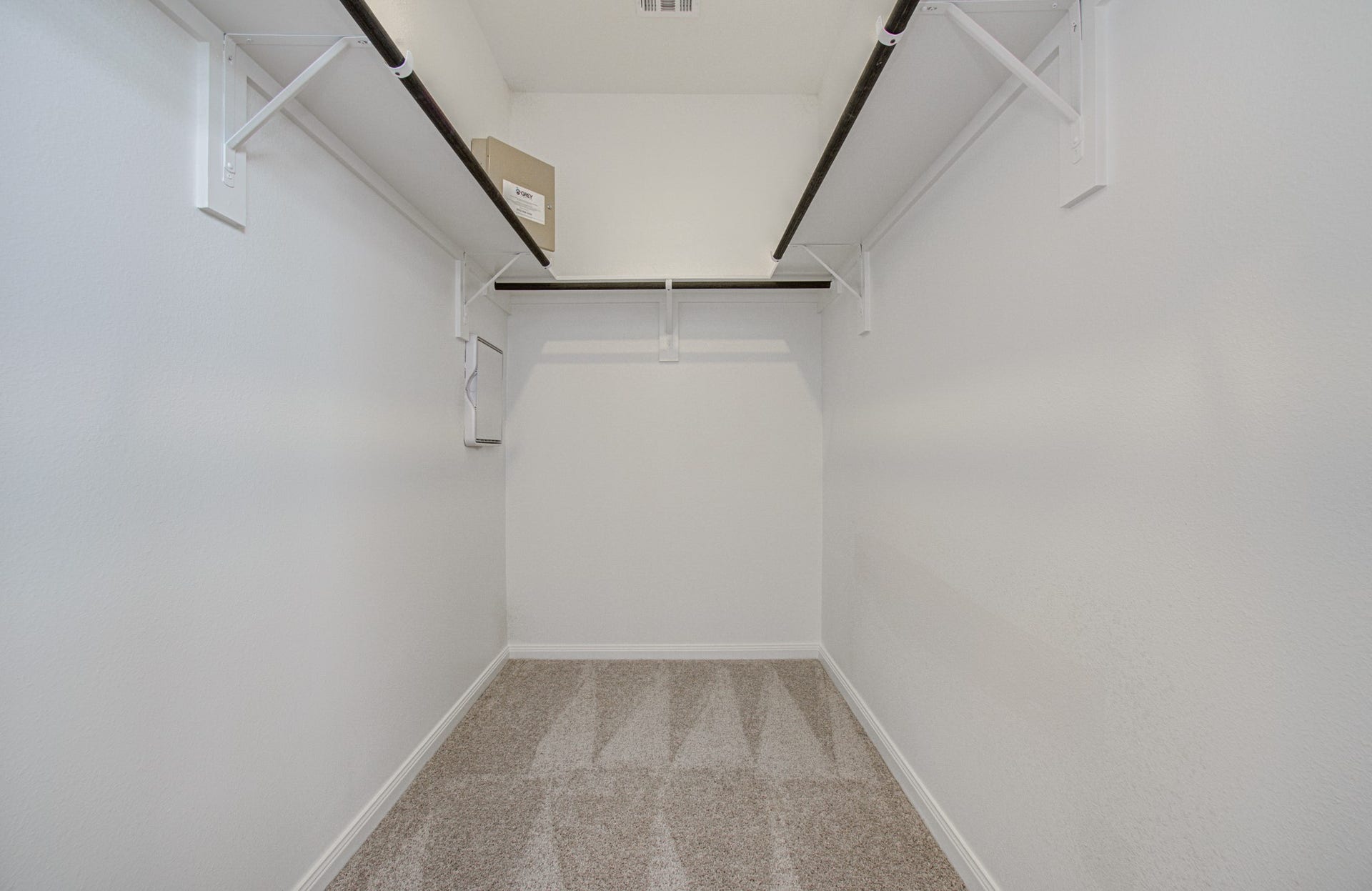 14210 Aston Pine Drive, Houston, TX 77032 Spacious walk-in closet with dual hanging rods and plush carpeting, ideal for organizing your wardrobe. Please Note this is a different home/floorplan in the community.