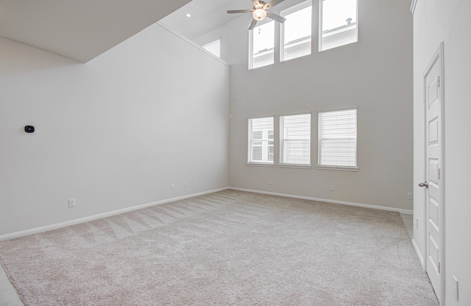 14210 Aston Pine Drive, Houston, TX 77032 Expansive living area with soaring ceilings and abundant natural light from large windows, perfect for relaxation or entertaining. Please Note this is a different home/floorplan in the community.