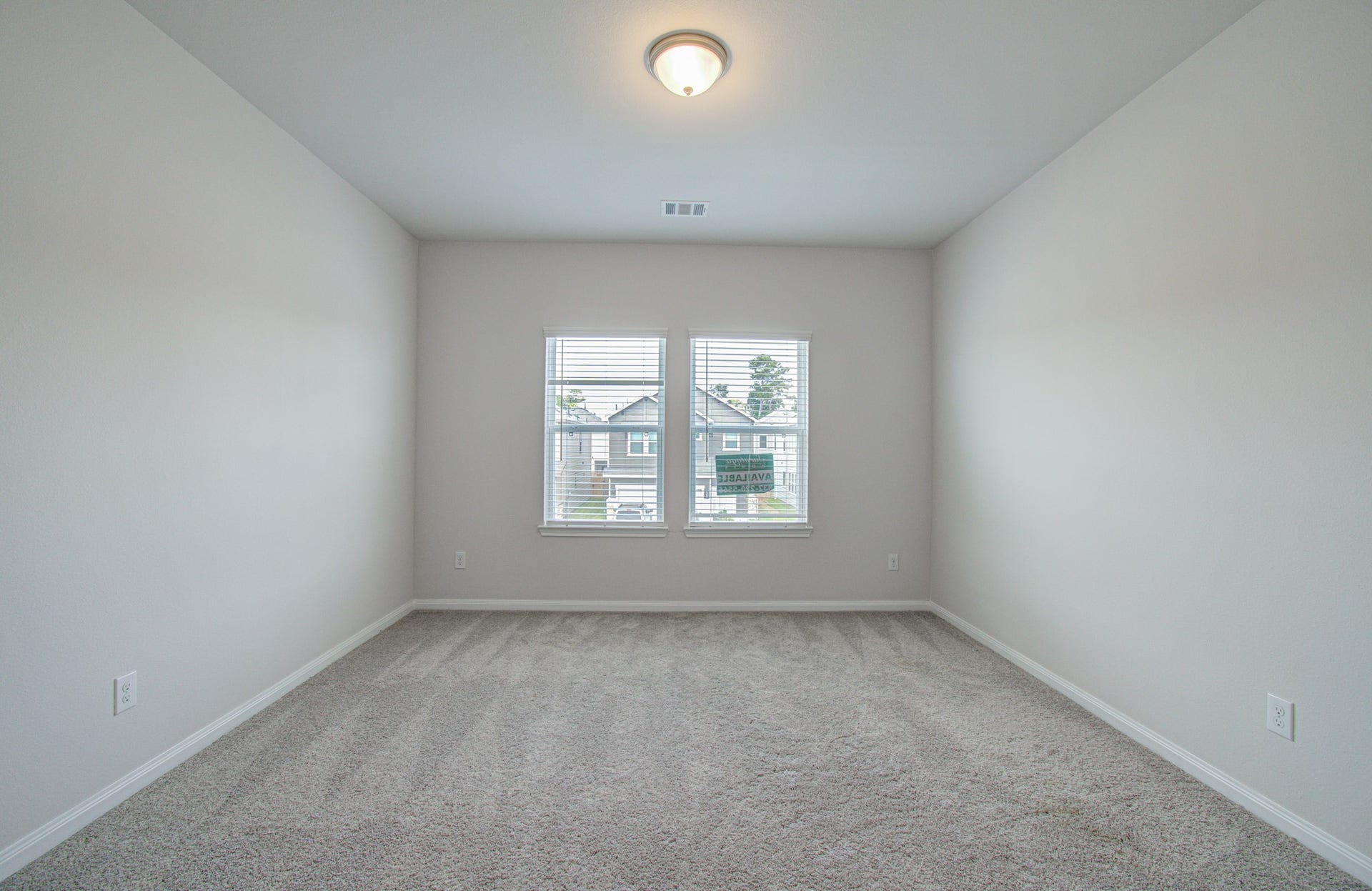 14210 Aston Pine Drive, Houston, TX 77032 Bright and spacious bedroom with soft carpeting, neutral walls, and a large window that invites natural light. Please Note this is a different home/floorplan in the community.