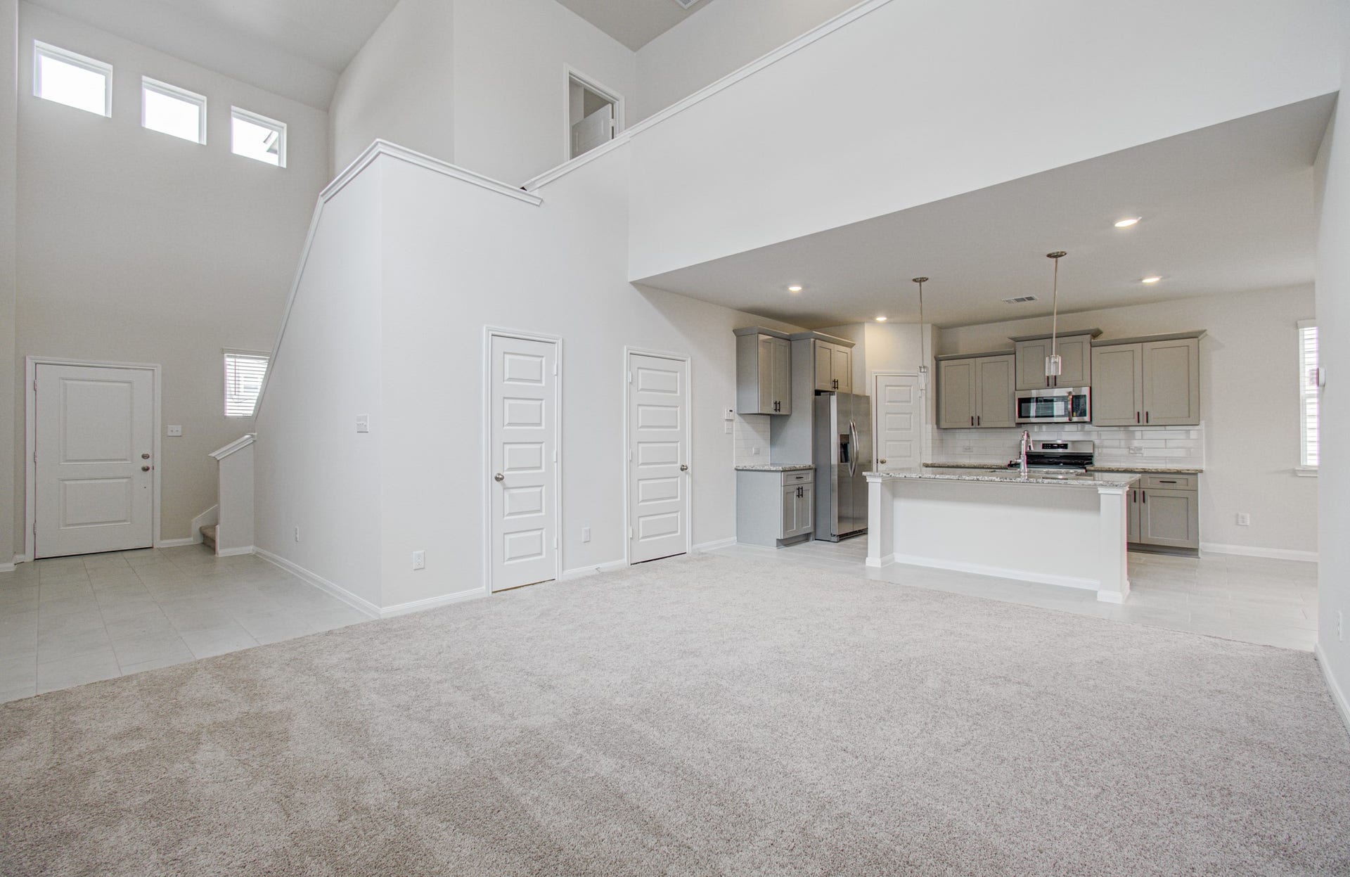14210 Aston Pine Drive, Houston, TX 77032 Spacious open-concept living with high ceilings, modern kitchen featuring stainless steel appliances, and abundant natural light. Please Note this is a different home/floorplan in the community.