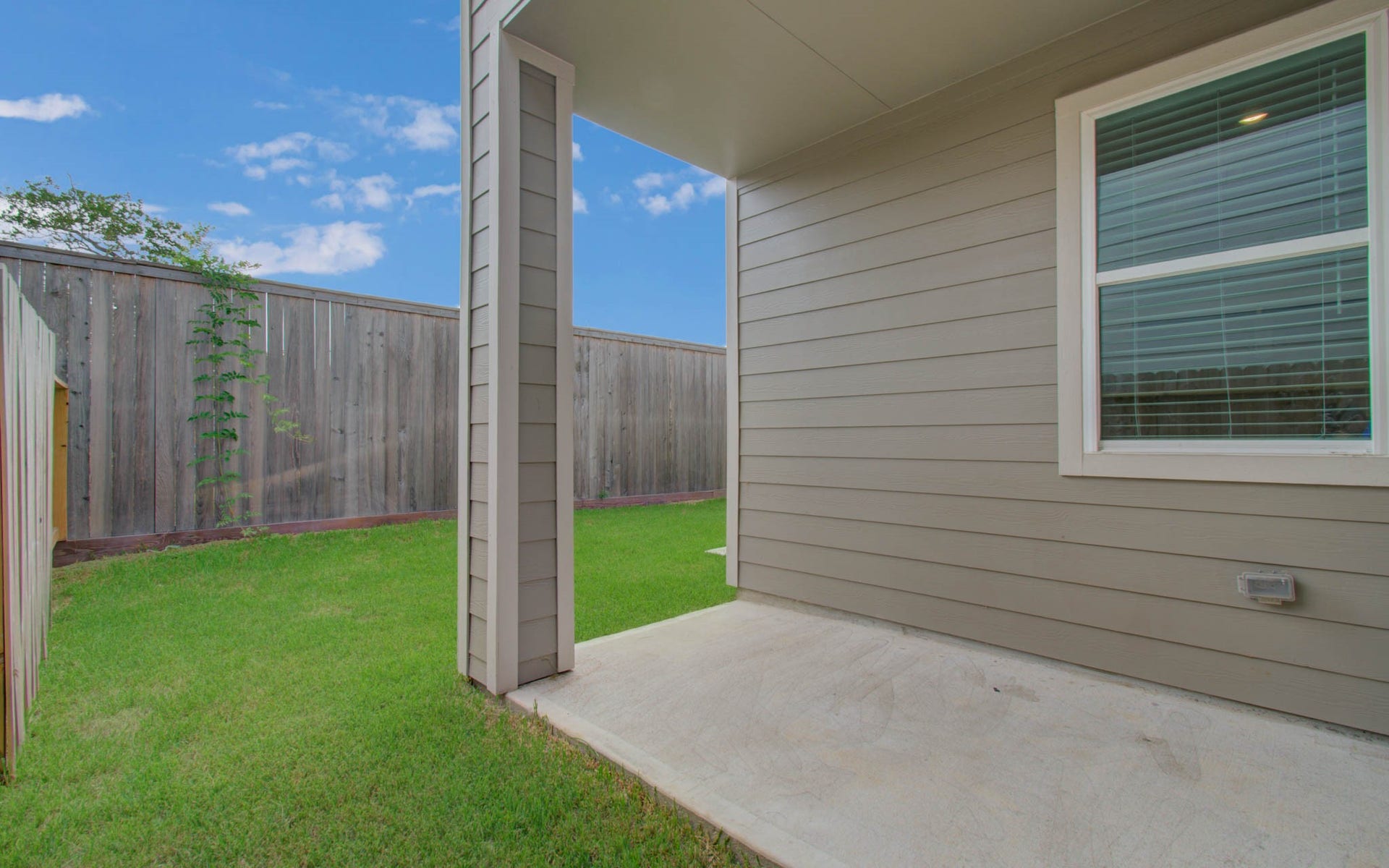 14210 Aston Pine Drive, Houston, TX 77032 Cozy backyard with a well-maintained lawn, privacy fence, and a covered patio area perfect for relaxing outdoors. Please Note this is a different home/floorplan in the community.