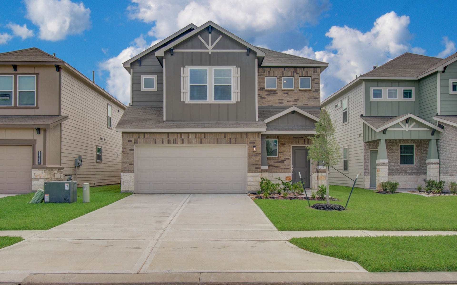 14210 Aston Pine Drive, Houston, TX 77032 Charming two-story home with a mix of brick and siding, featuring a spacious double garage and a neatly landscaped front yard. Please Note this is a different home/floorplan in the community.