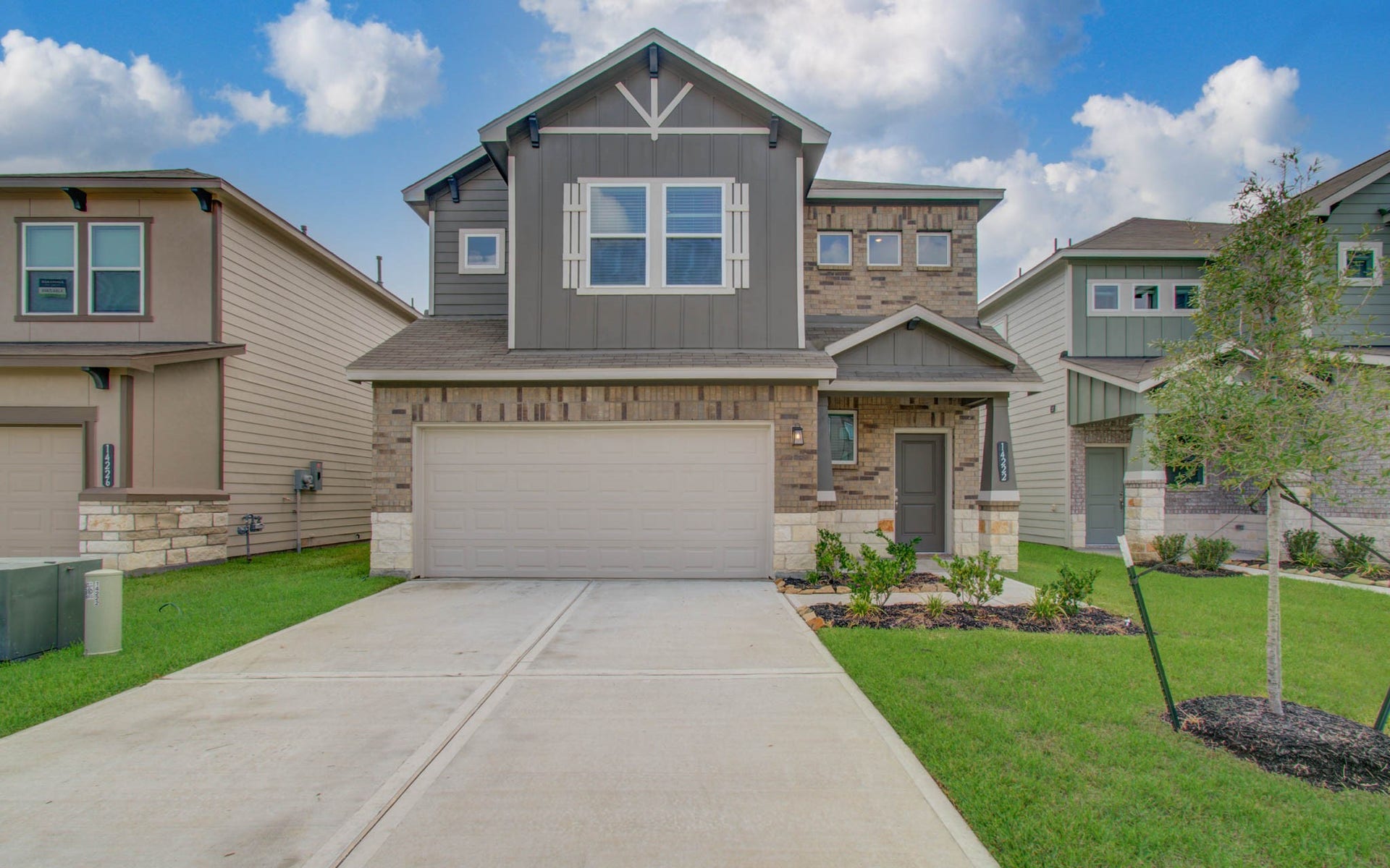 14210 Aston Pine Drive, Houston, TX 77032 Please Note this is a different home/floorplan in the community. Charming two-story home with a modern facade, featuring a mix of brick and siding, a spacious two-car garage.