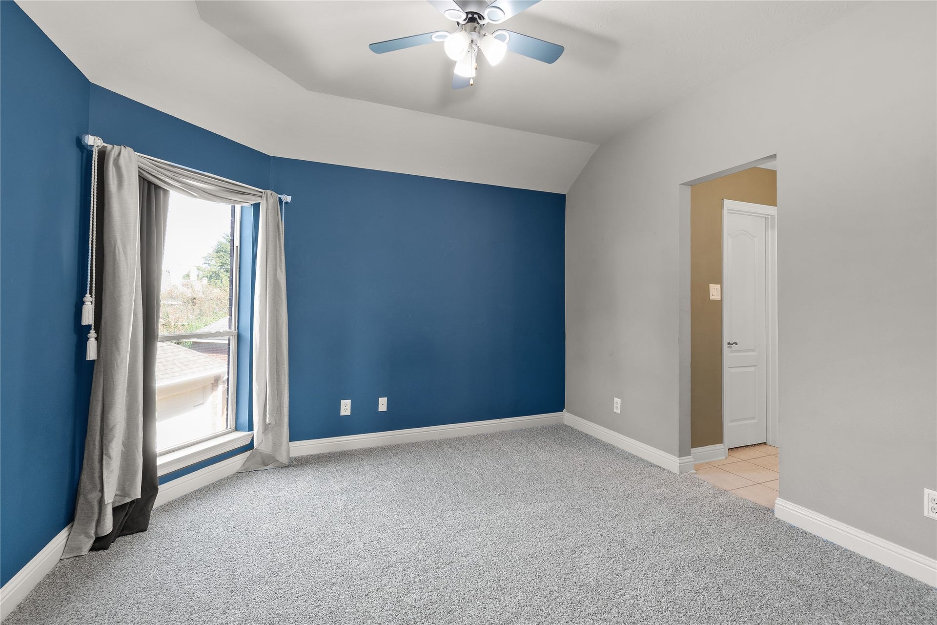 11 Saint Thomas Court, Houston, TX 77070 This inviting secondary bedroom features soft carpeting, a ceiling fan and natural light, providing a comfortable and versatile space for guests or everyday living.