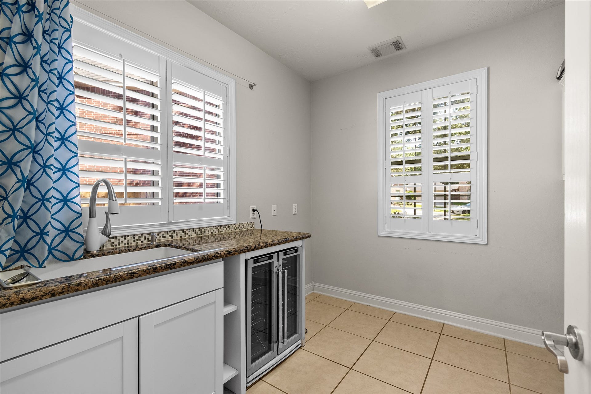11 Saint Thomas Court, Houston, TX 77070 A spacious utility room with built-in cabinetry, a countertop workspace and natural light makes everyday household tasks more organized and convenient.